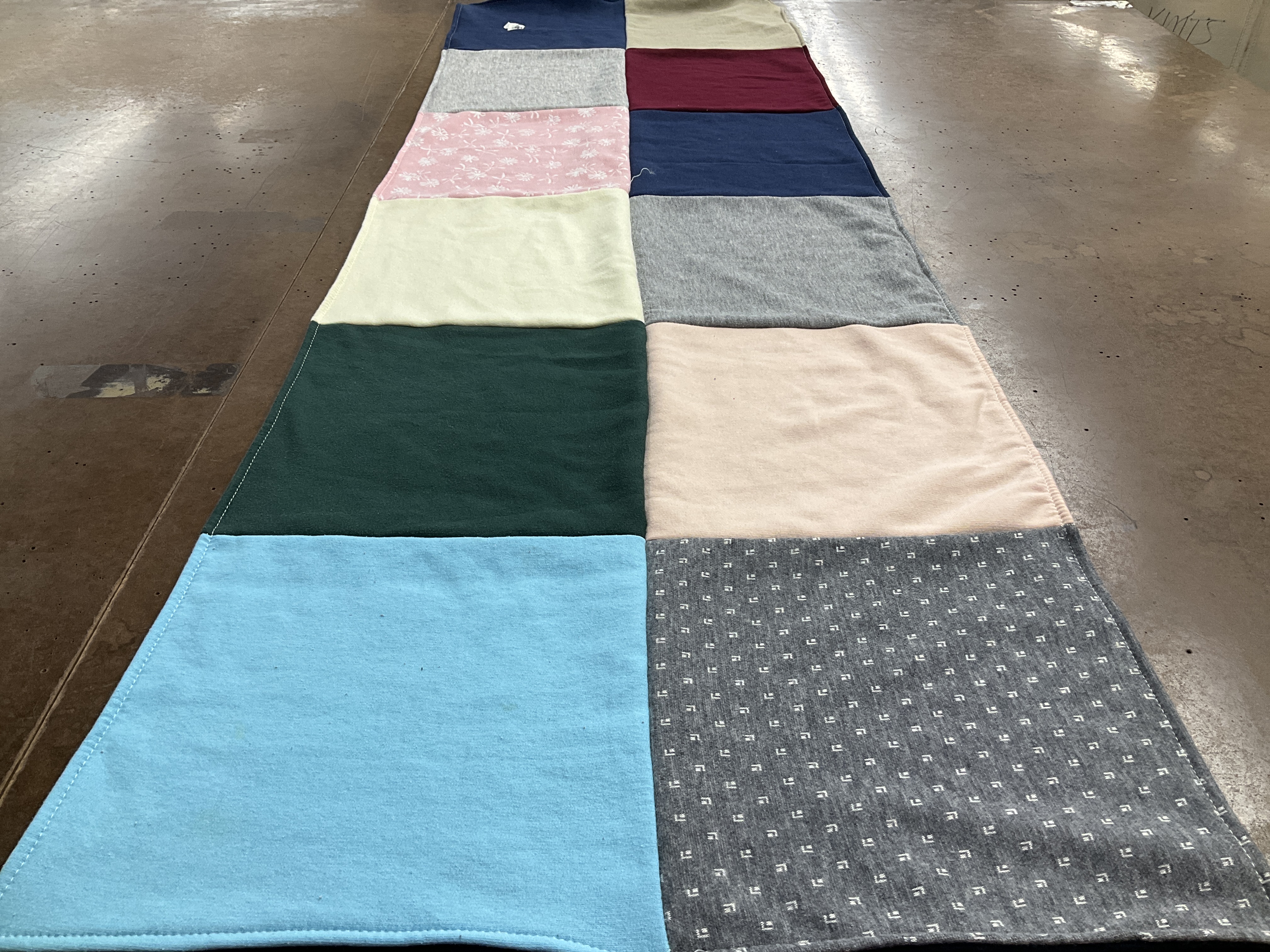Custom Project Repat t-shirt quilt highlighting quilting, sewing themes.