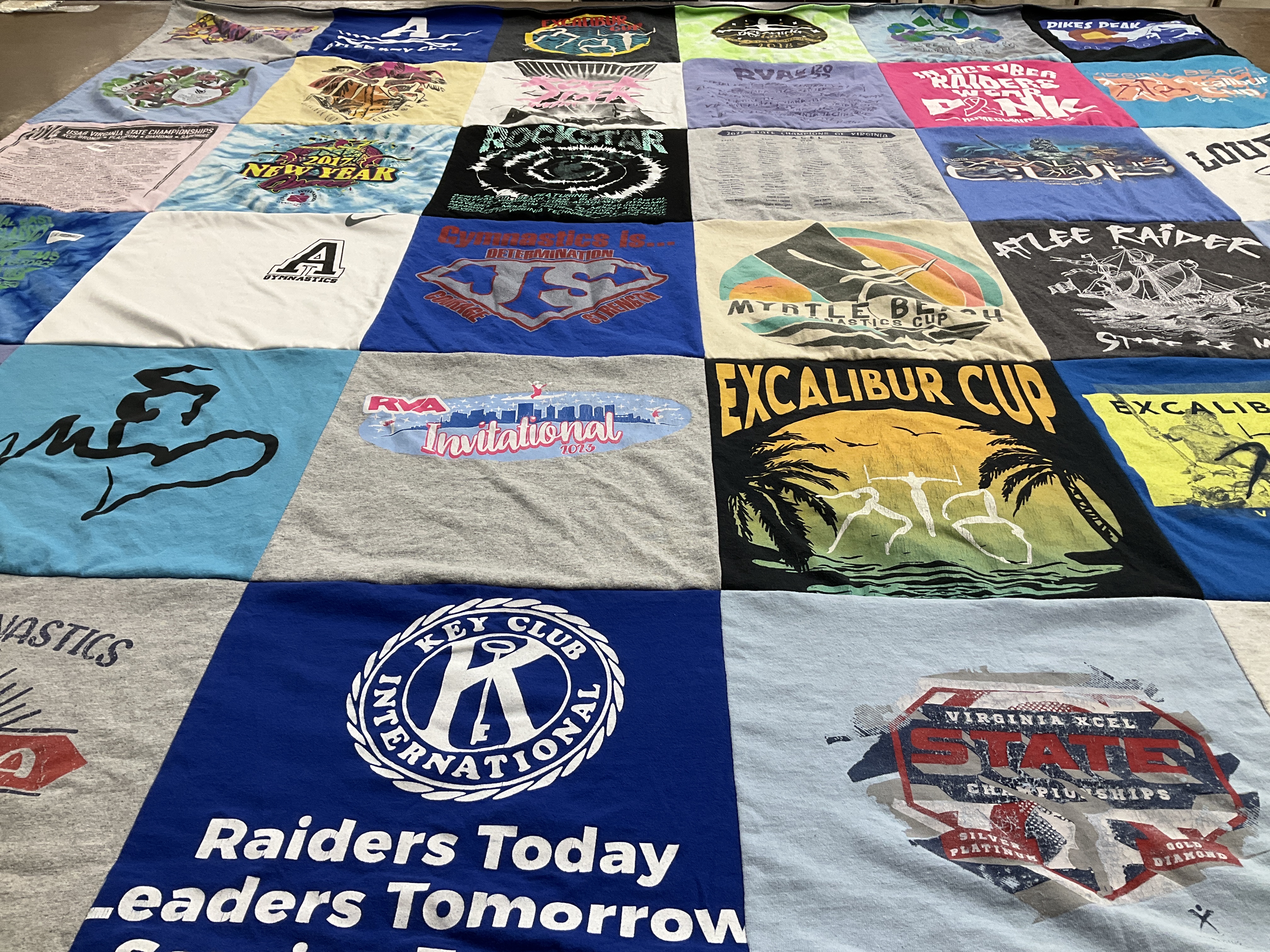 Custom Project Repat t-shirt quilt highlighting gymnastics, sports themes.