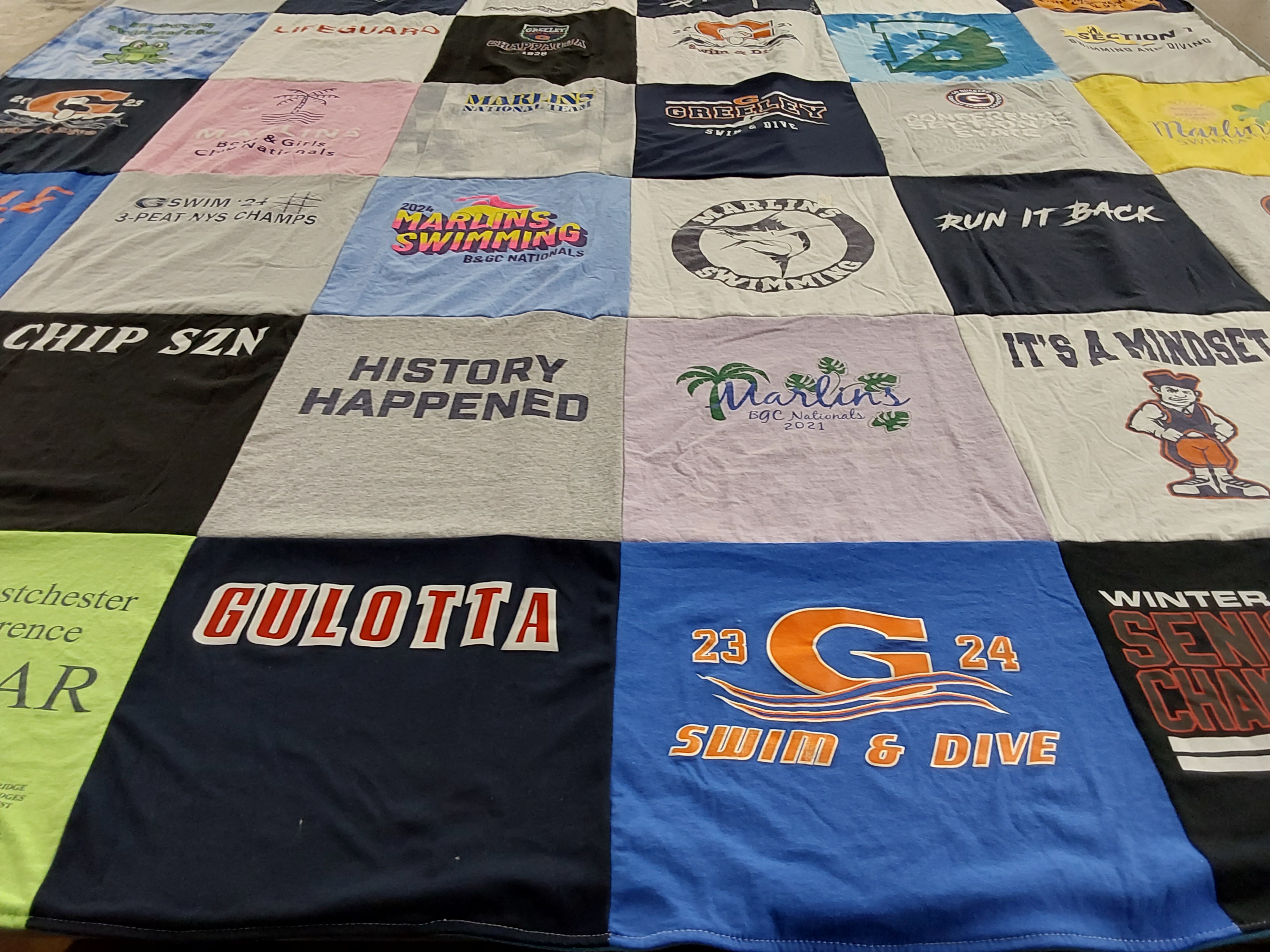 Custom Project Repat t-shirt quilt featuring shirts from greeley swim and dive.