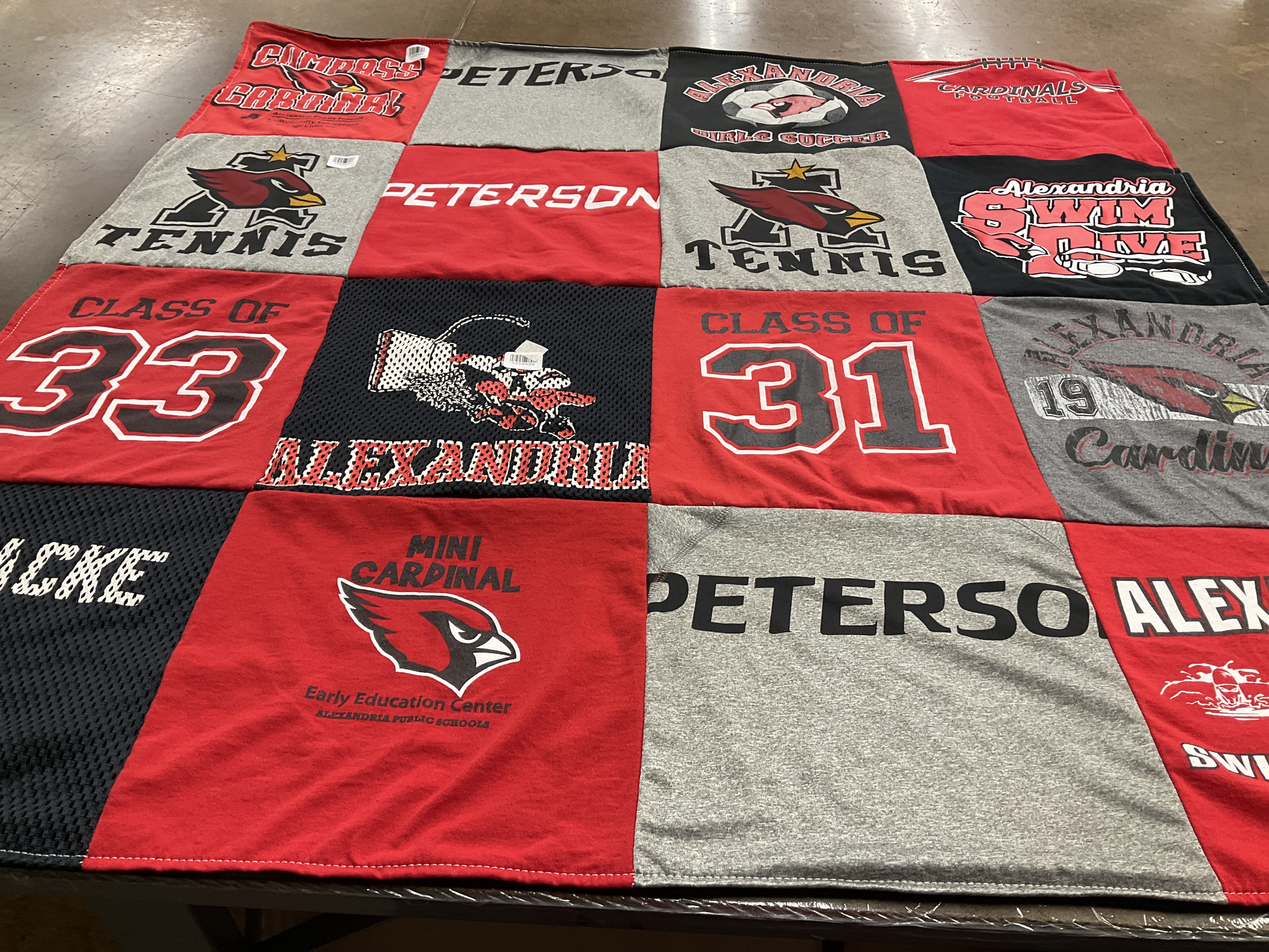 Custom Project Repat t-shirt quilt featuring shirts from alexandria public schools.