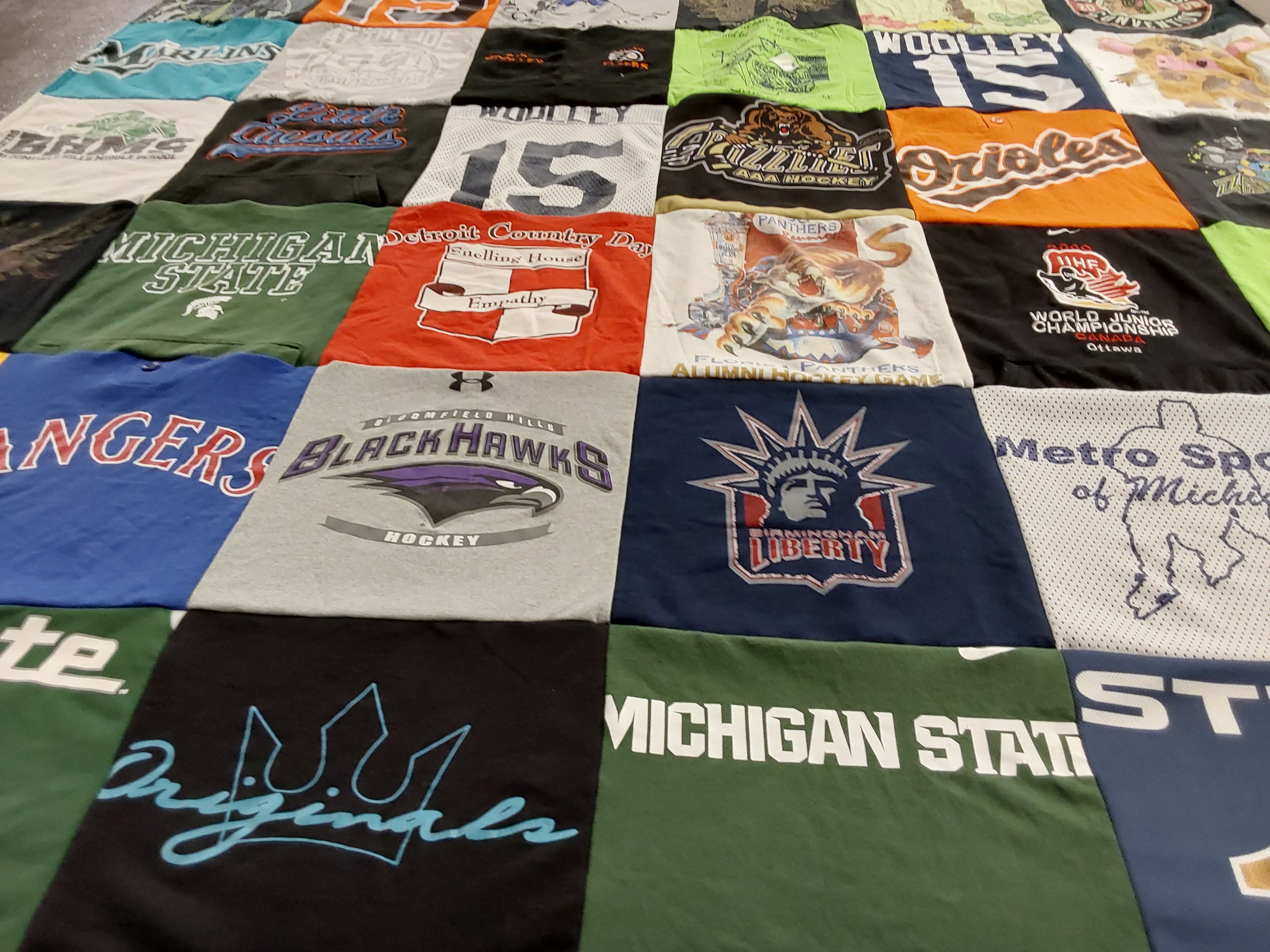 T-shirt quilt featuring black hawks, rangers by Danica from MI