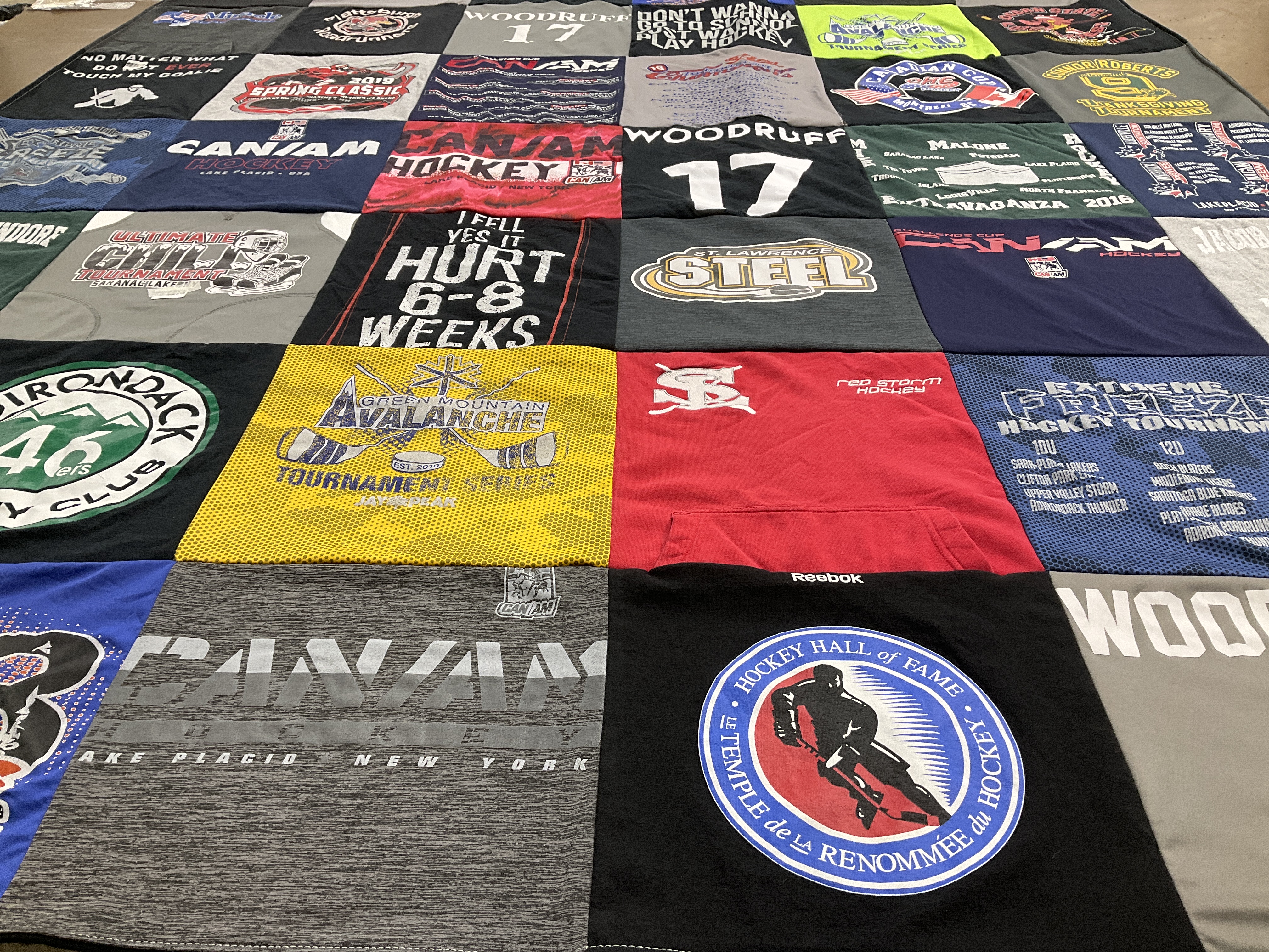 T-shirt quilt featuring green mountain avalanche, red storm hockey by Rebecca from NY