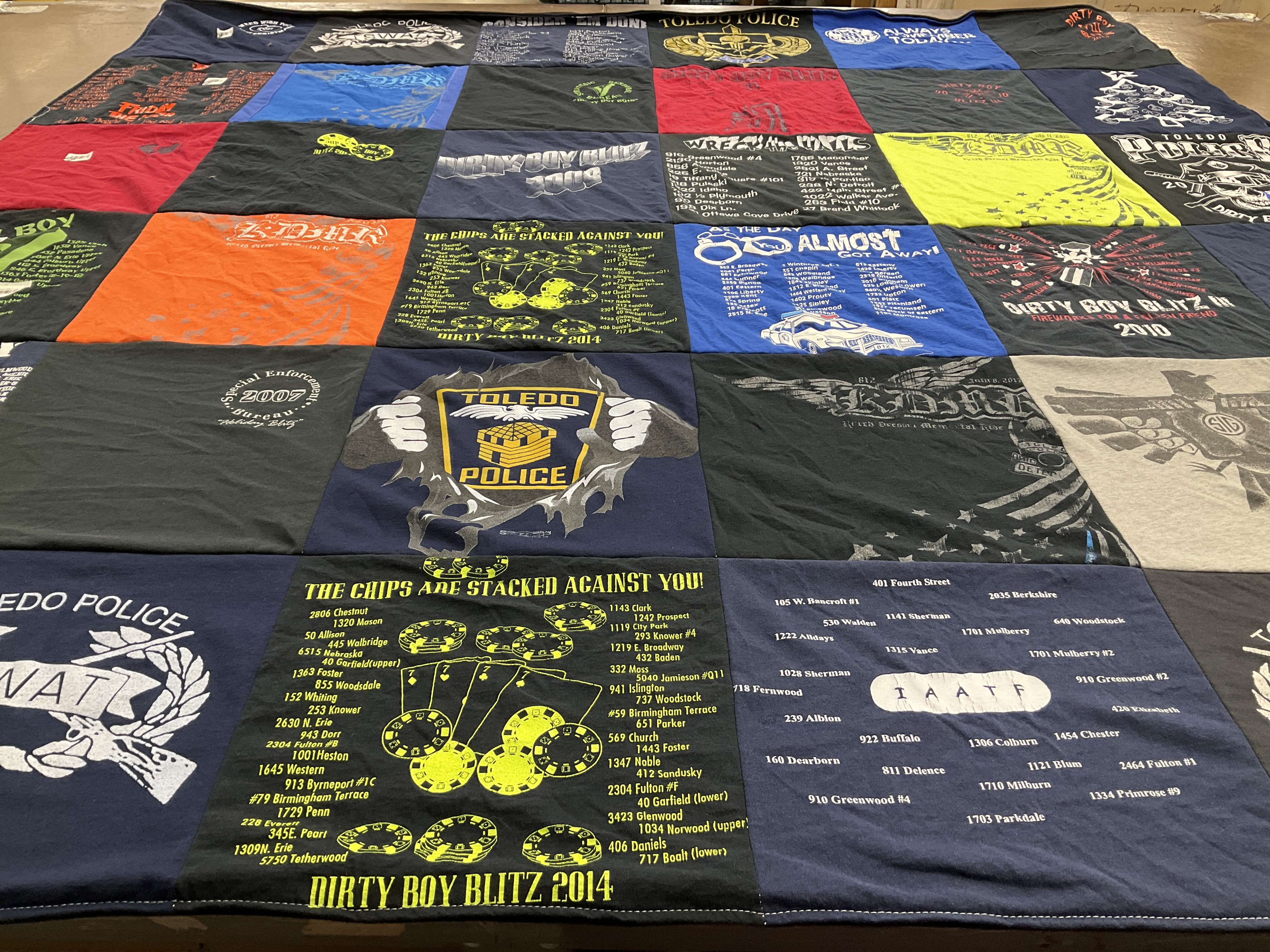 Custom Project Repat t-shirt quilt highlighting law enforcement, wrestling themes.