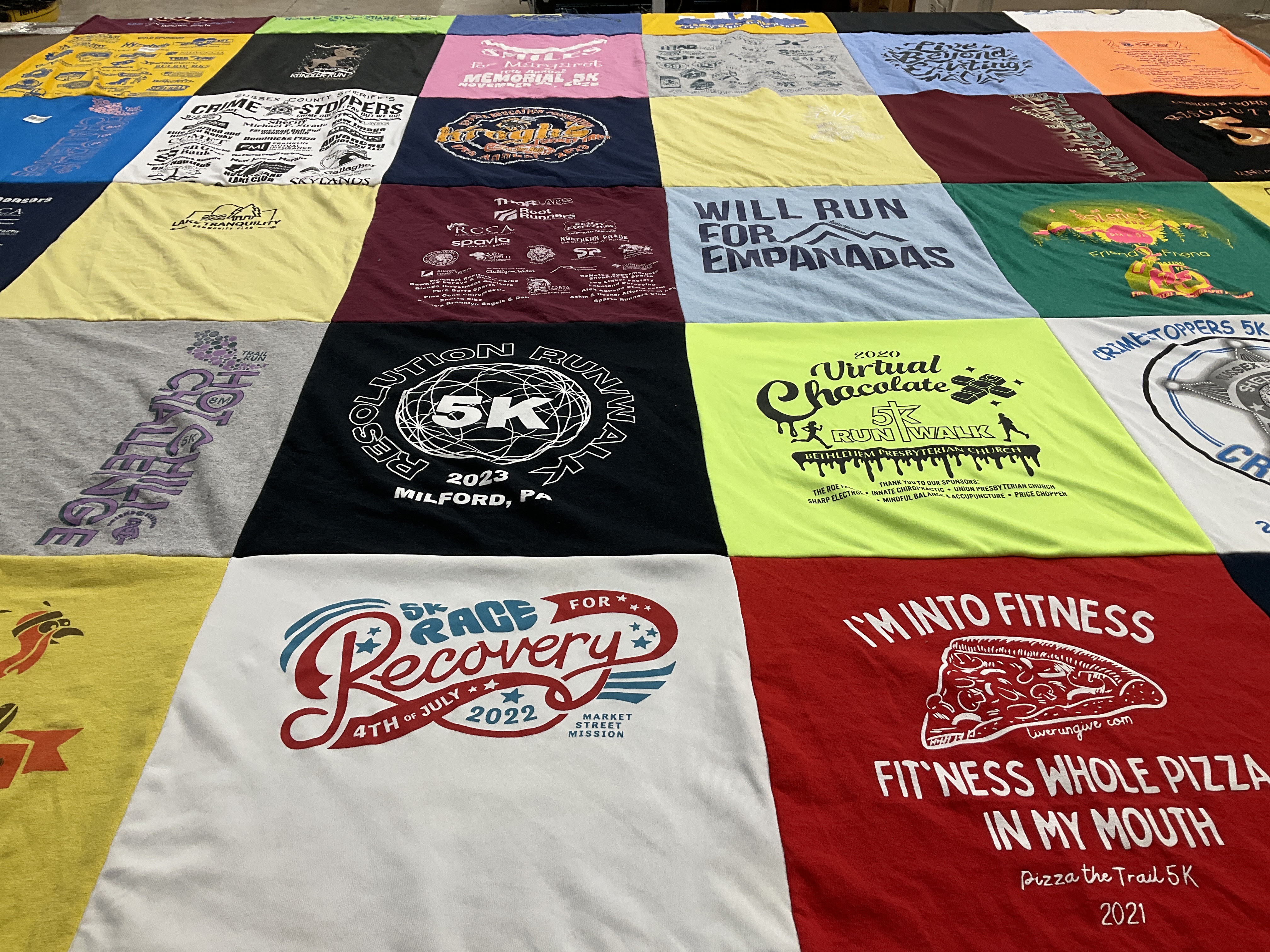 Custom Project Repat t-shirt quilt highlighting running, fitness themes.