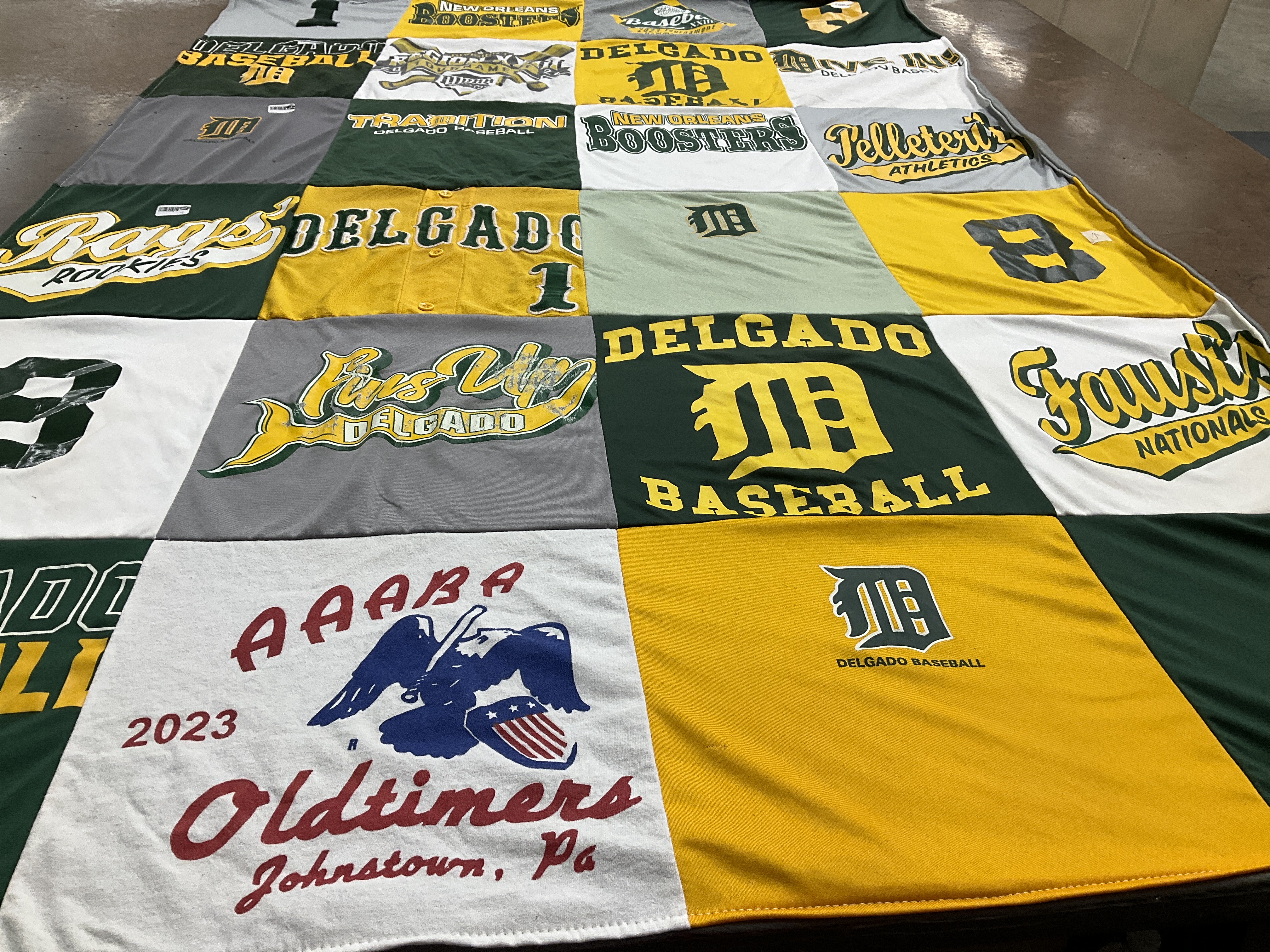 Custom Project Repat t-shirt quilt featuring shirts from delgado community college.