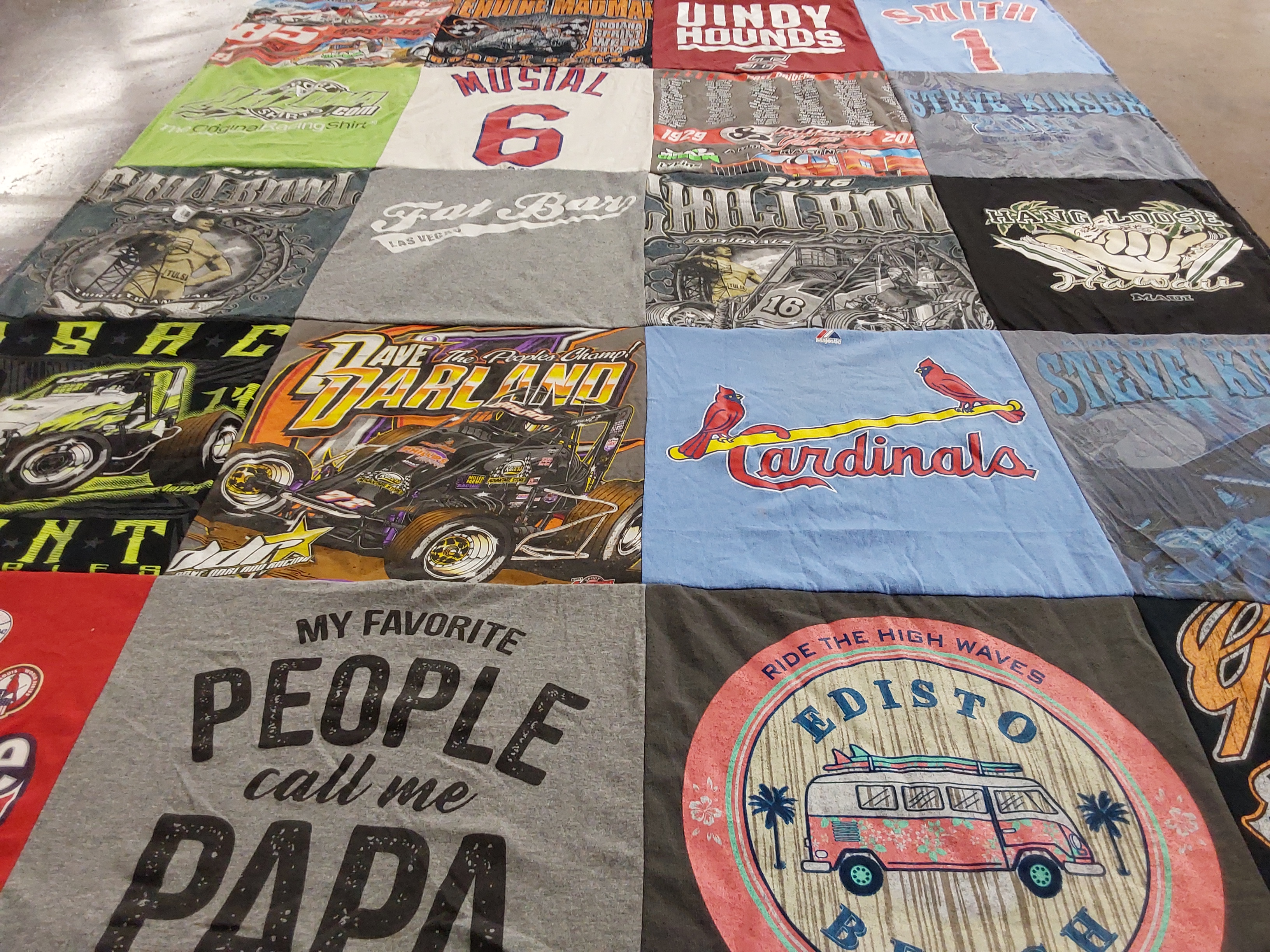 Custom Project Repat t-shirt quilt highlighting racing, fishing themes.