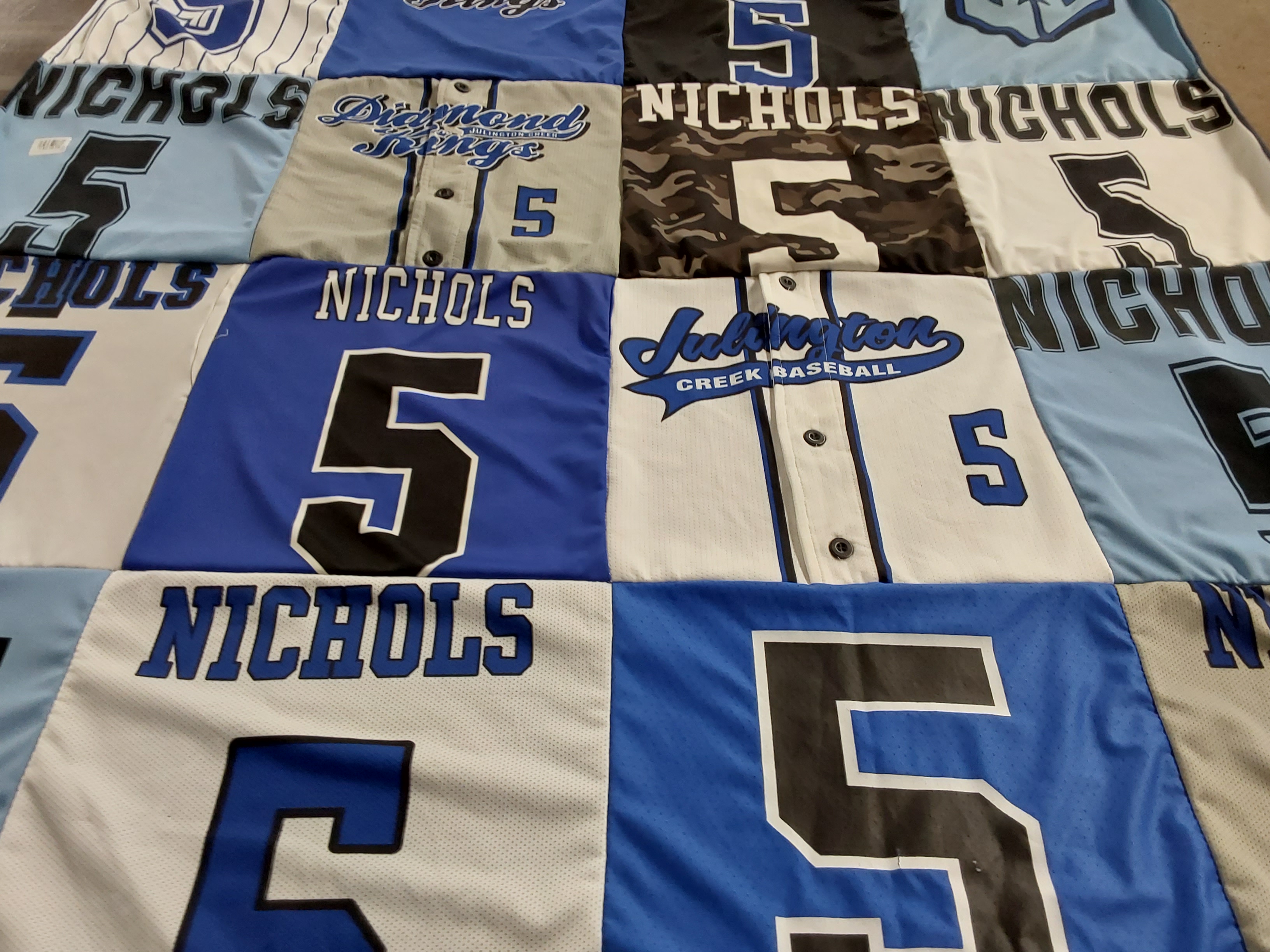 Custom Project Repat t-shirt quilt highlighting baseball themes.