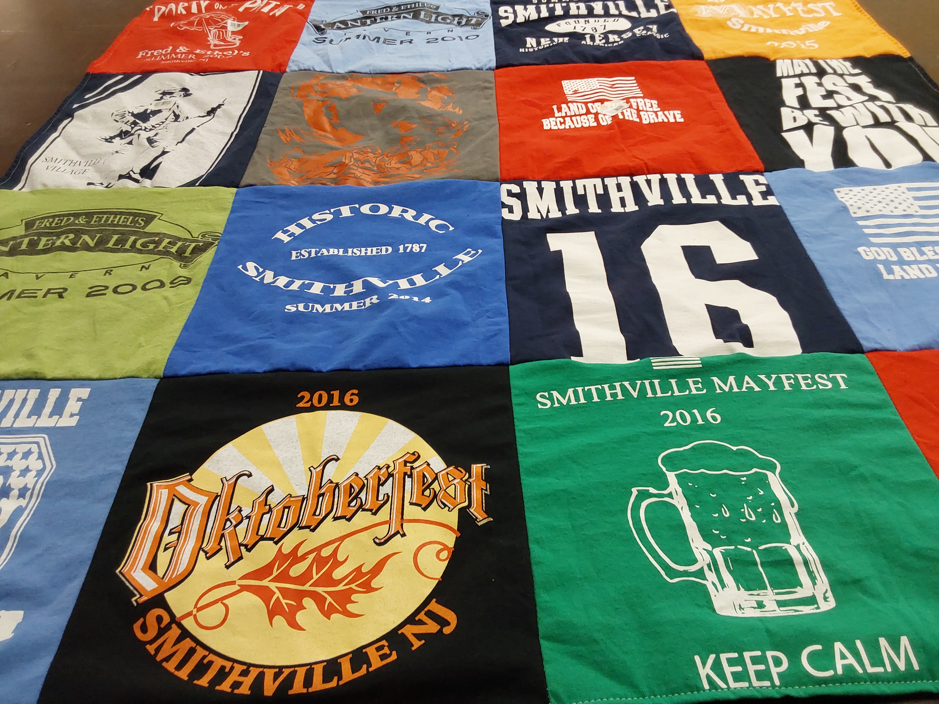 T-shirt quilt with festivals, community events themes by Laura from PA