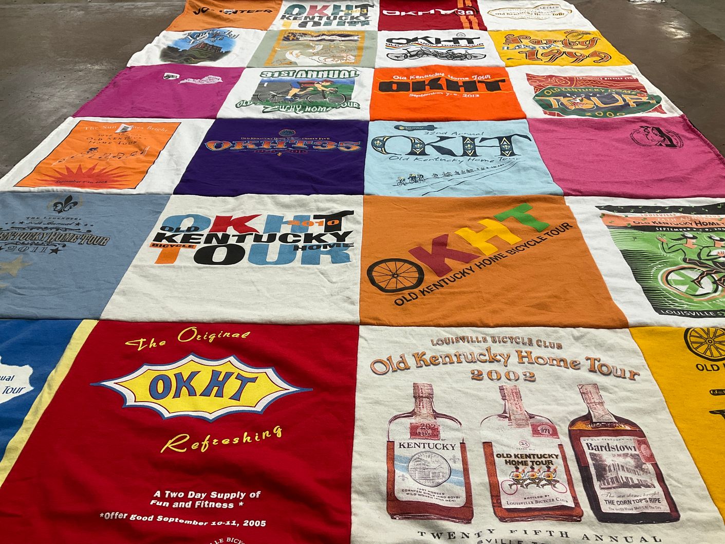 T-shirt quilt with cycling, community events themes by Rita from KY