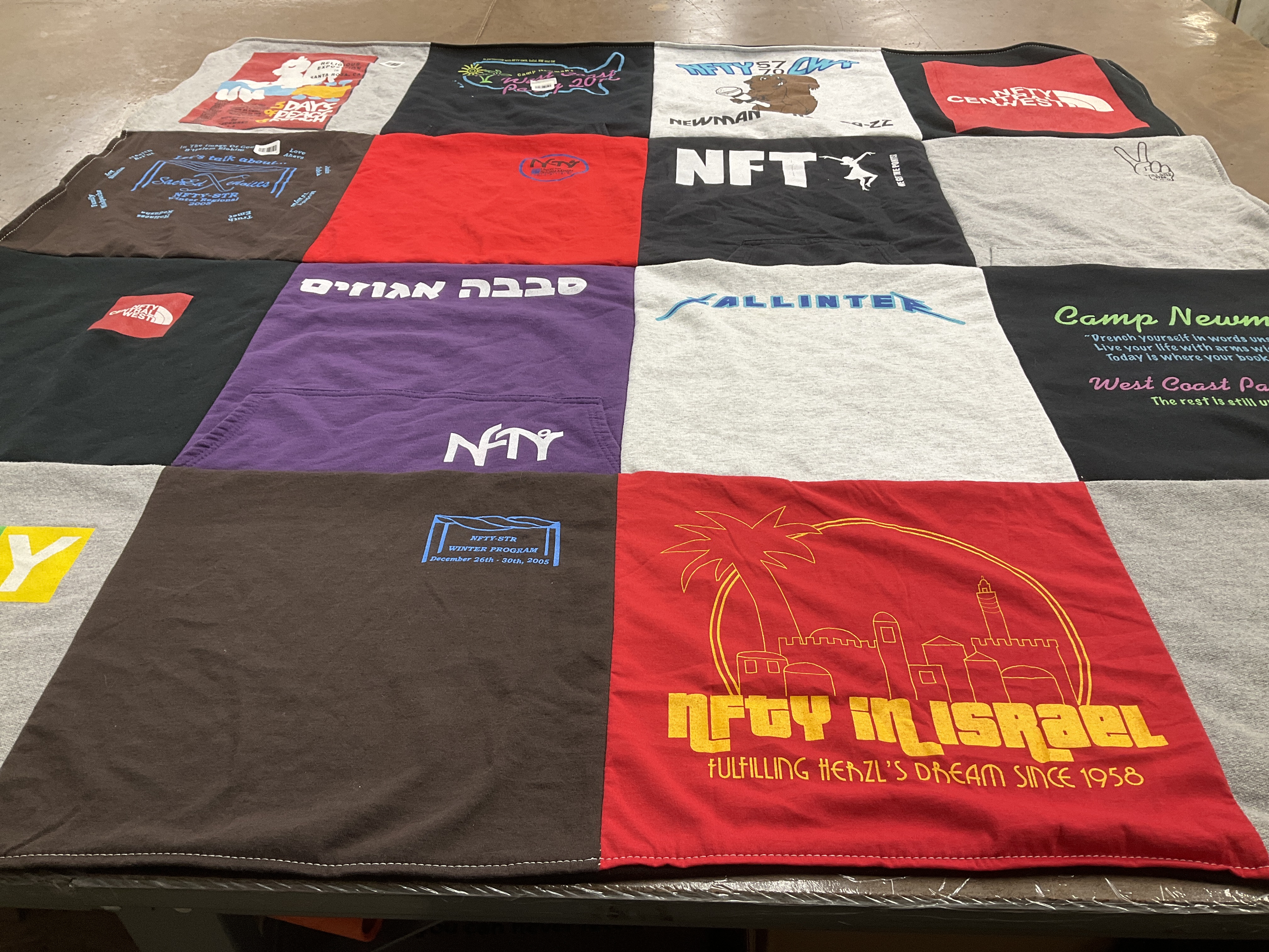 T-shirt quilt with youth organizations, community service themes by Laura from CA