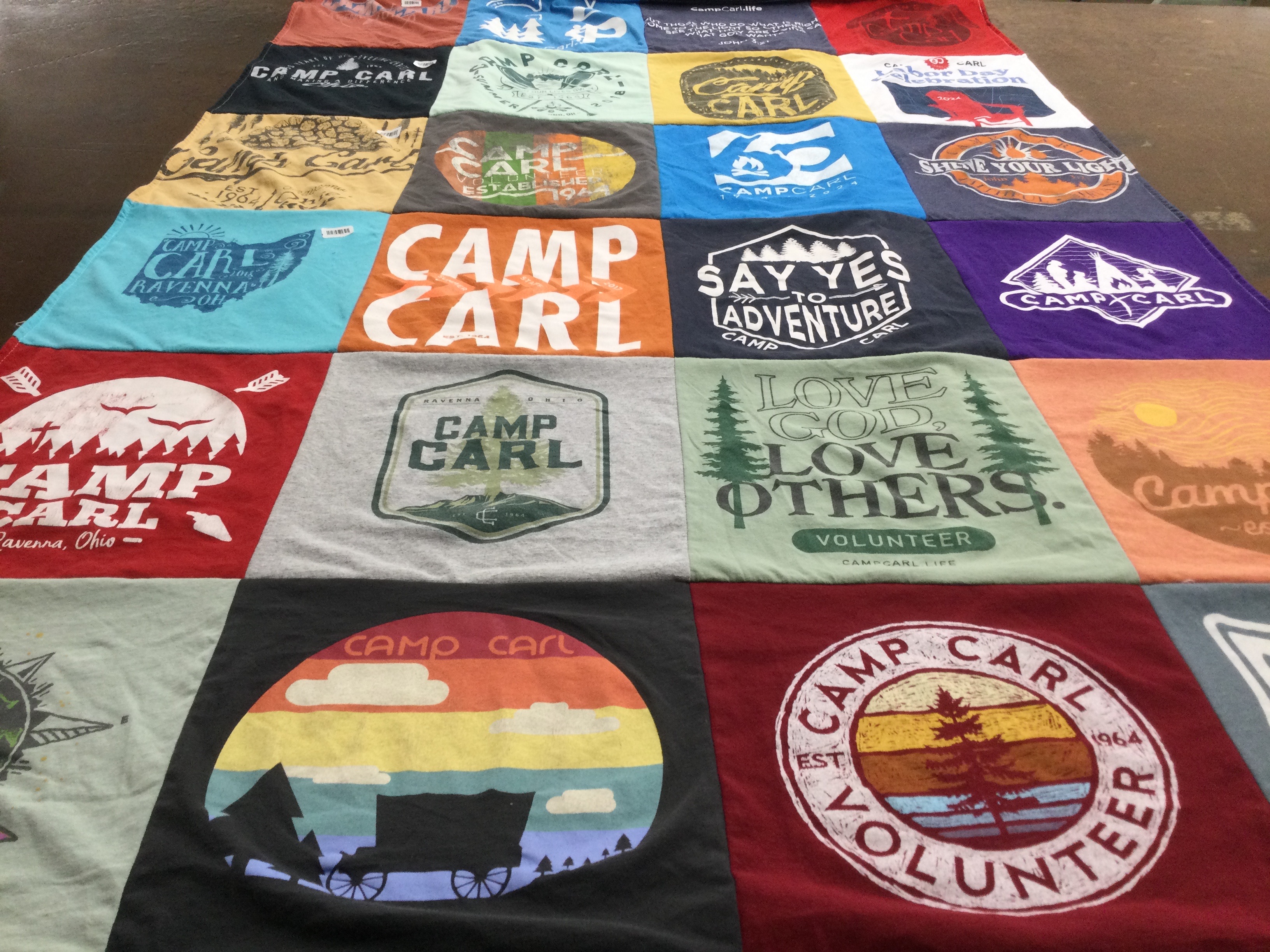 T-shirt quilt with camping, volunteering themes by Mary from OH