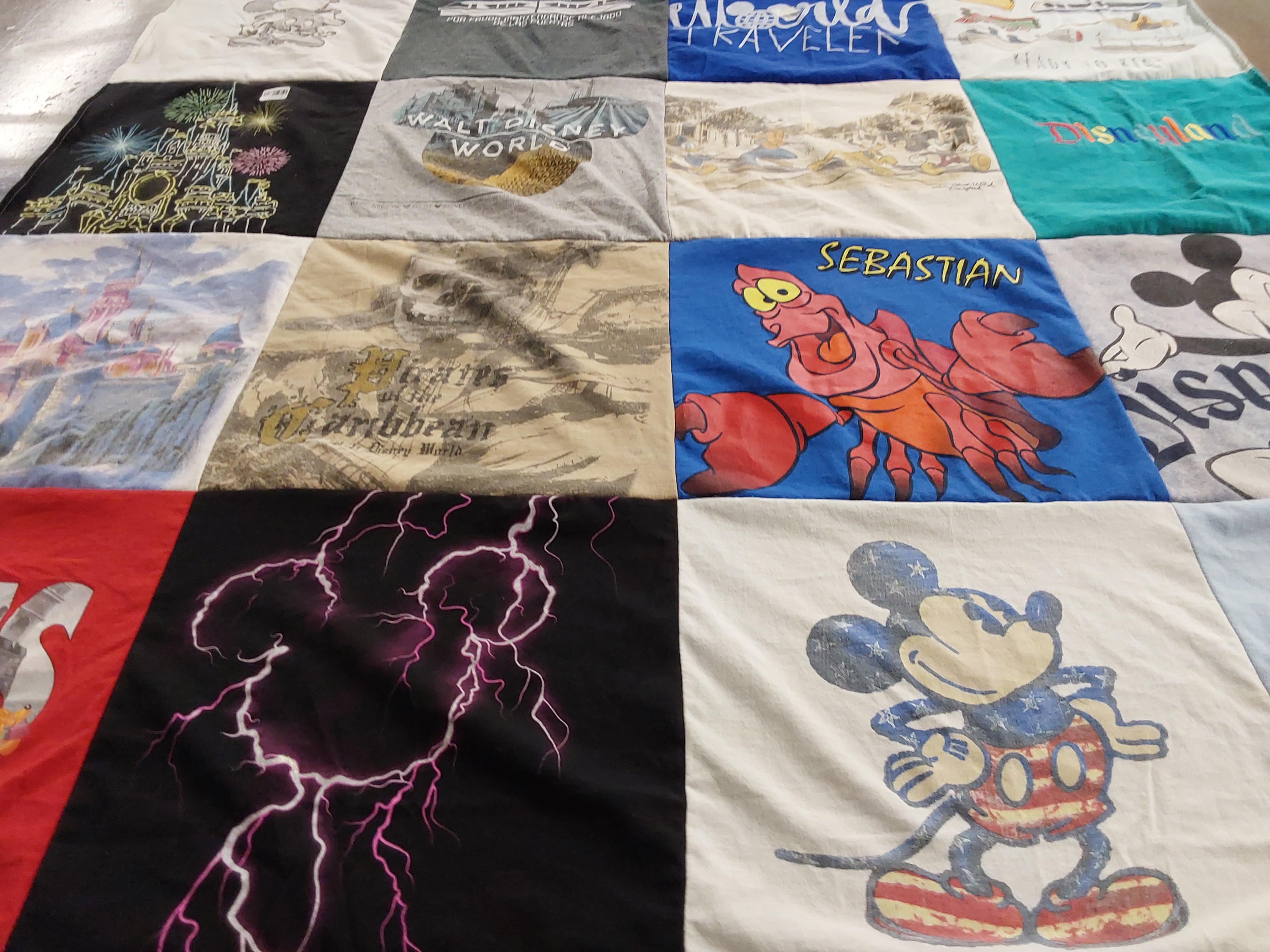 T-shirt quilt with disney, travel themes by Holly from NJ