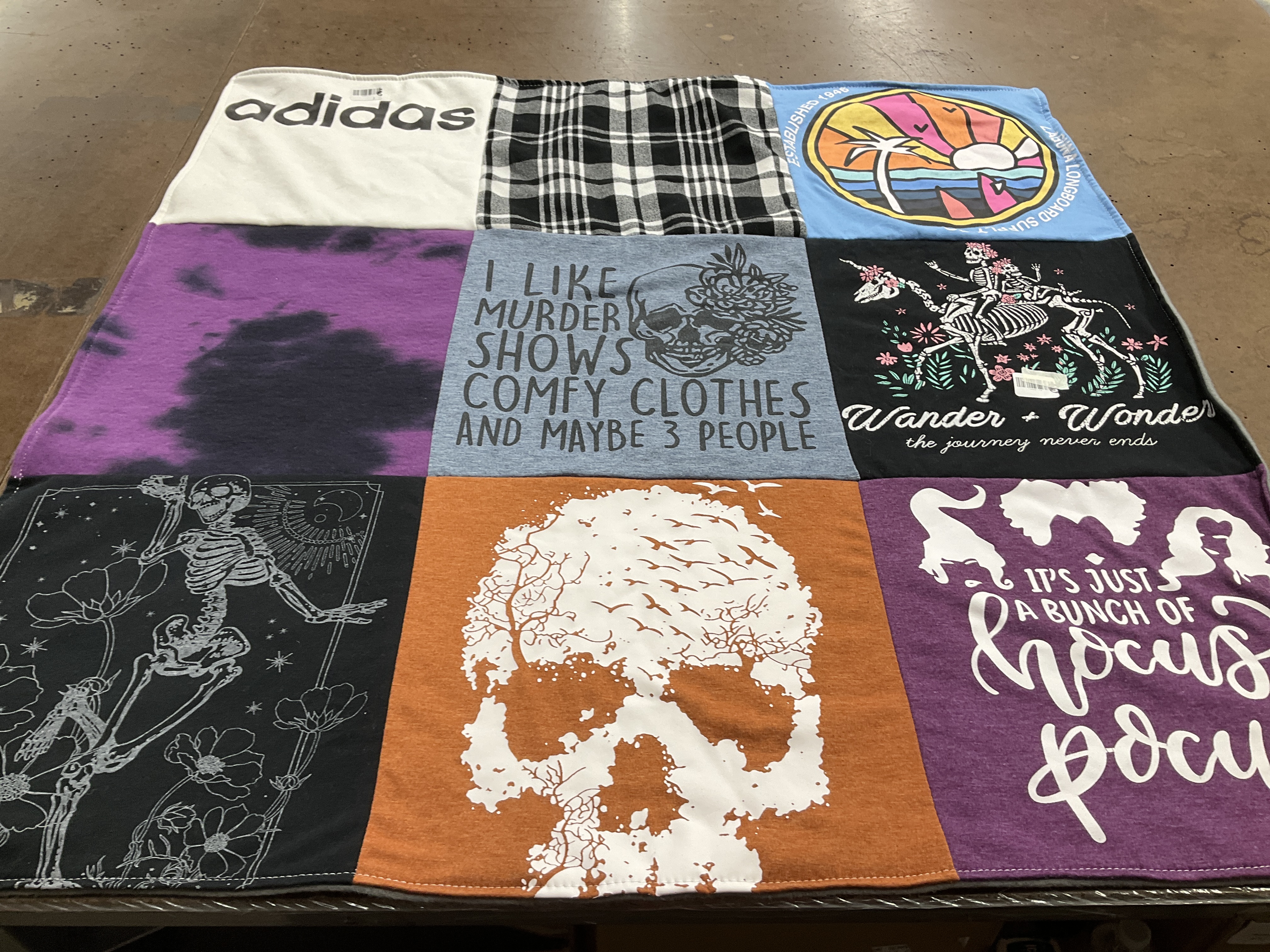 T-shirt quilt with murder mystery, travel themes by Mikela from CA