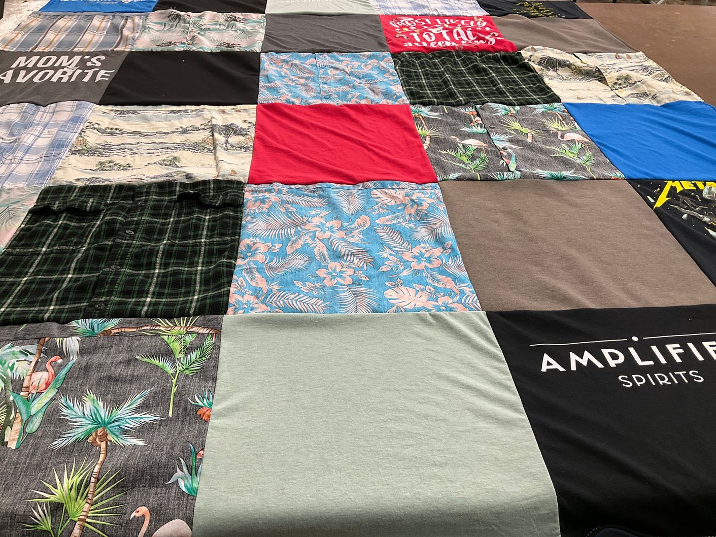 T-shirt quilt with family themes by Rachel from MI