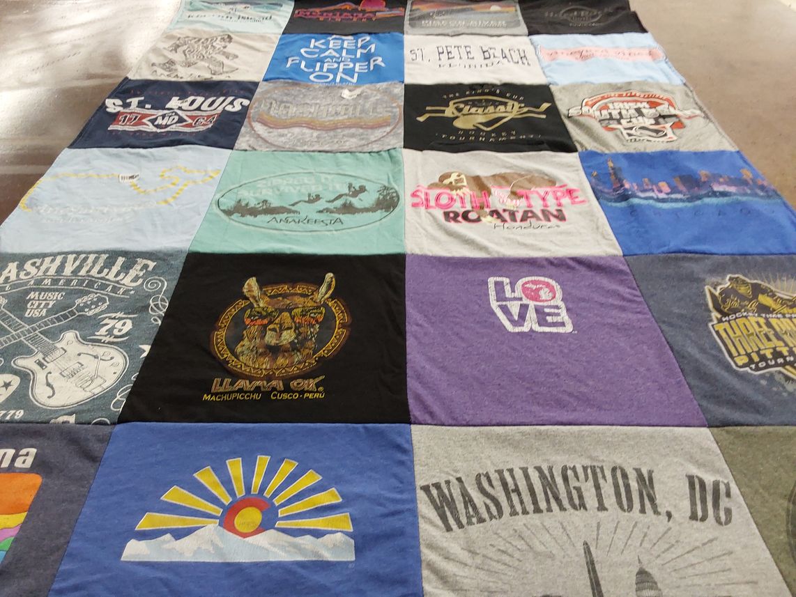 T-shirt quilt with travel, music themes by Mari from MI
