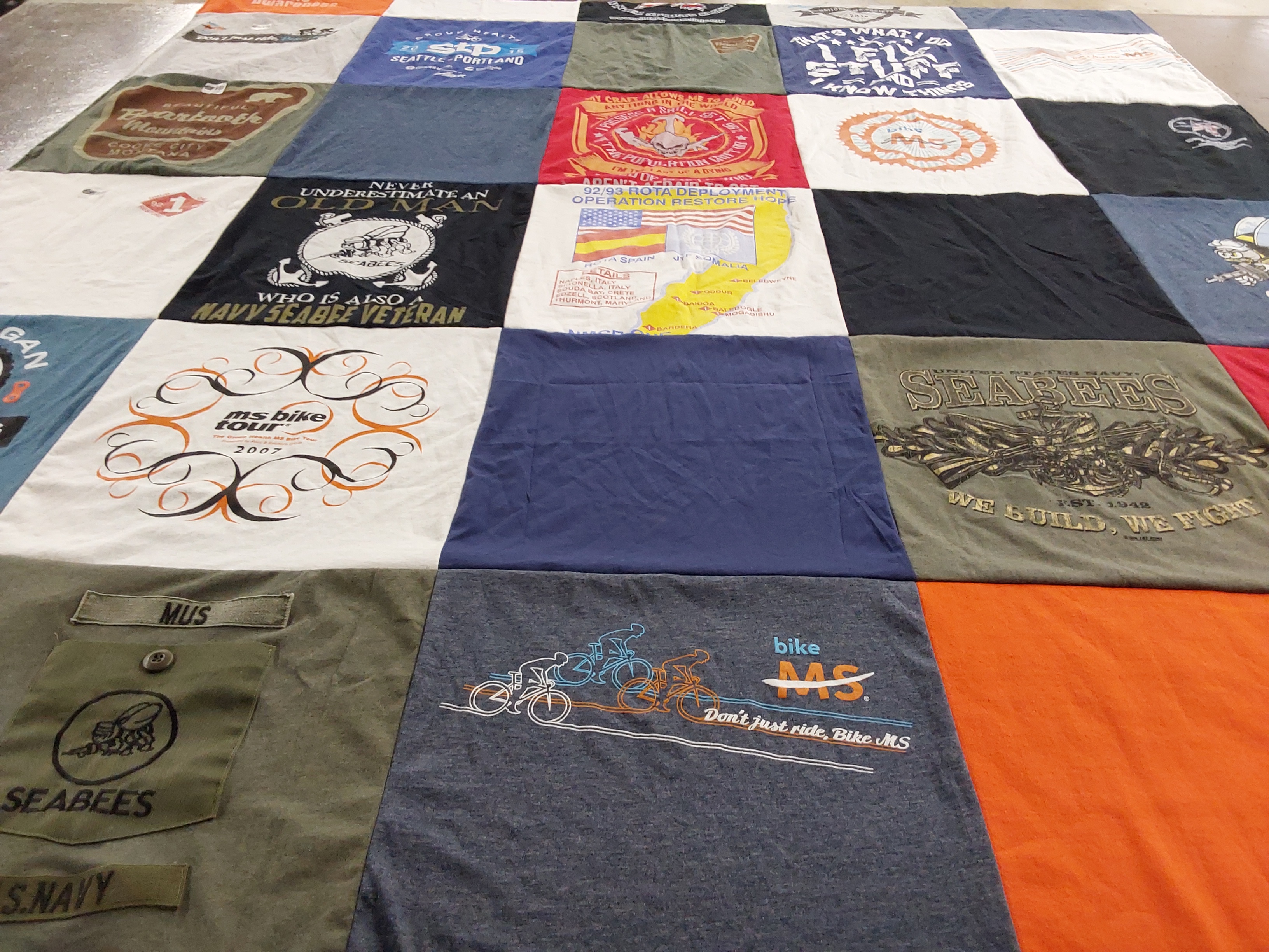 T-shirt quilt with cycling, military themes by Carol from MA
