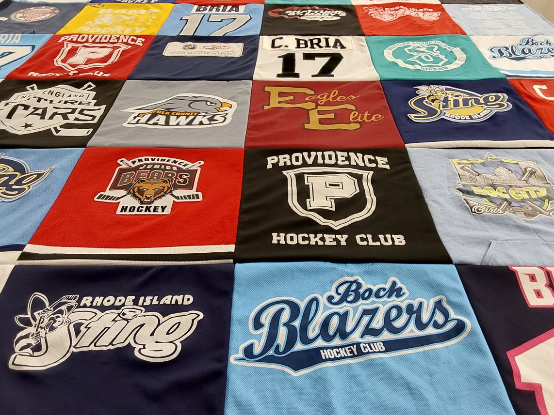 T-shirt quilt with hockey, sports themes by Lynn from RI