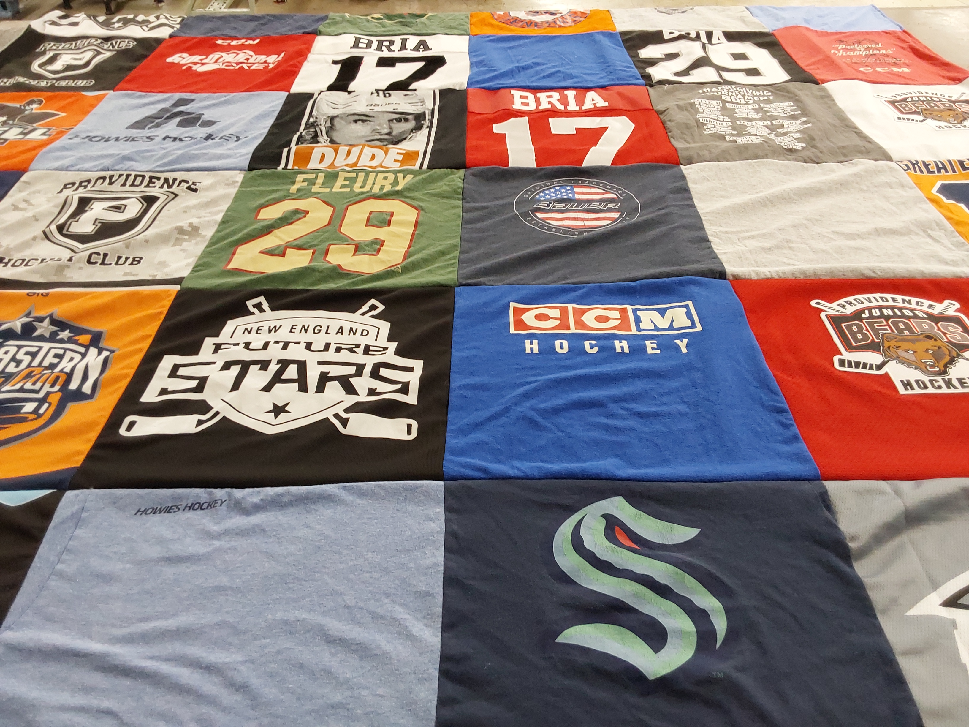 T-shirt quilt with hockey, sports themes by Lynn from RI