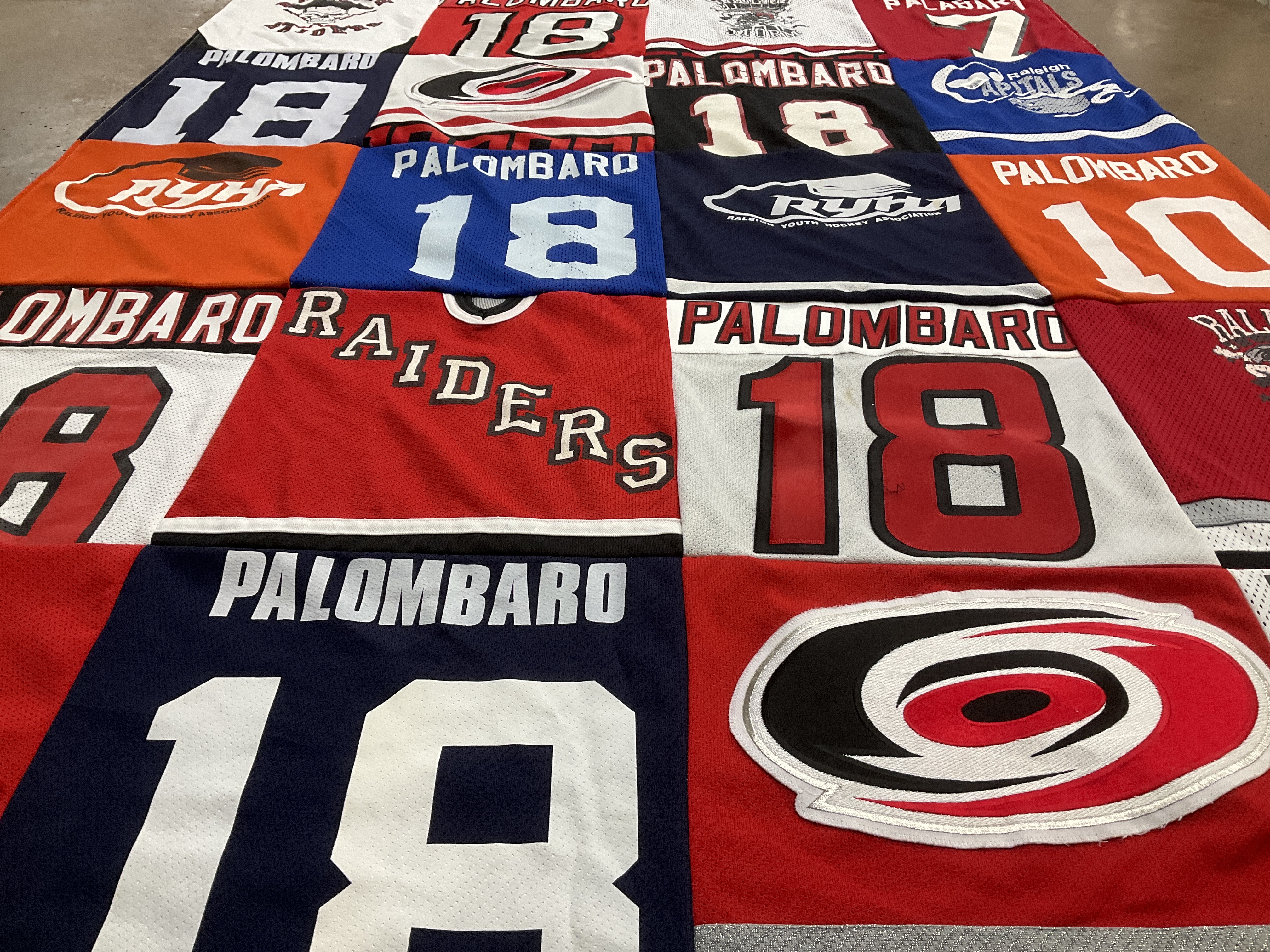 T-shirt quilt with hockey, sports themes by Jim from NC