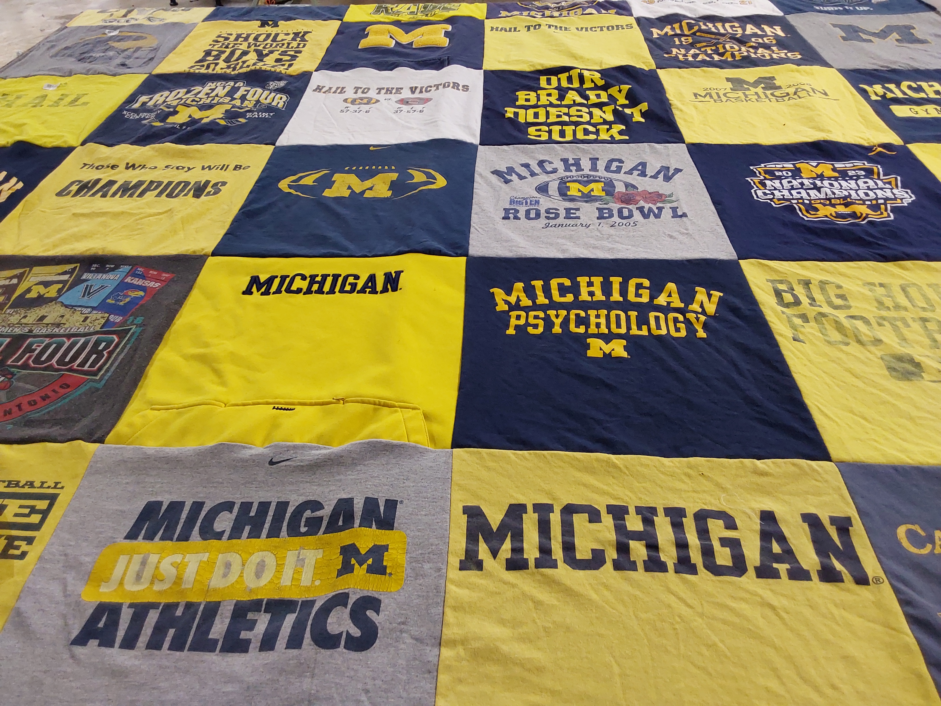 T-shirt quilt featuring university of michigan football, university of michigan basketball by Amy from MI