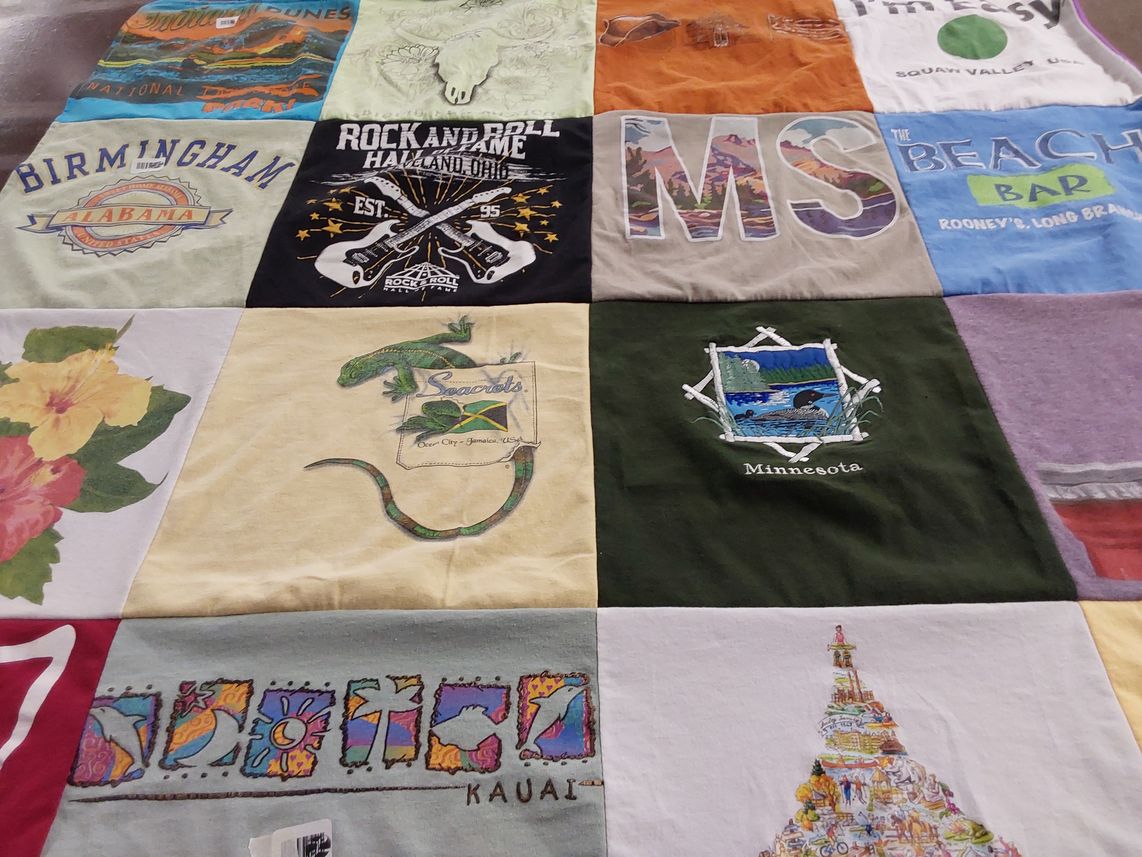 T-shirt quilt with travel, music themes by Christine from NJ