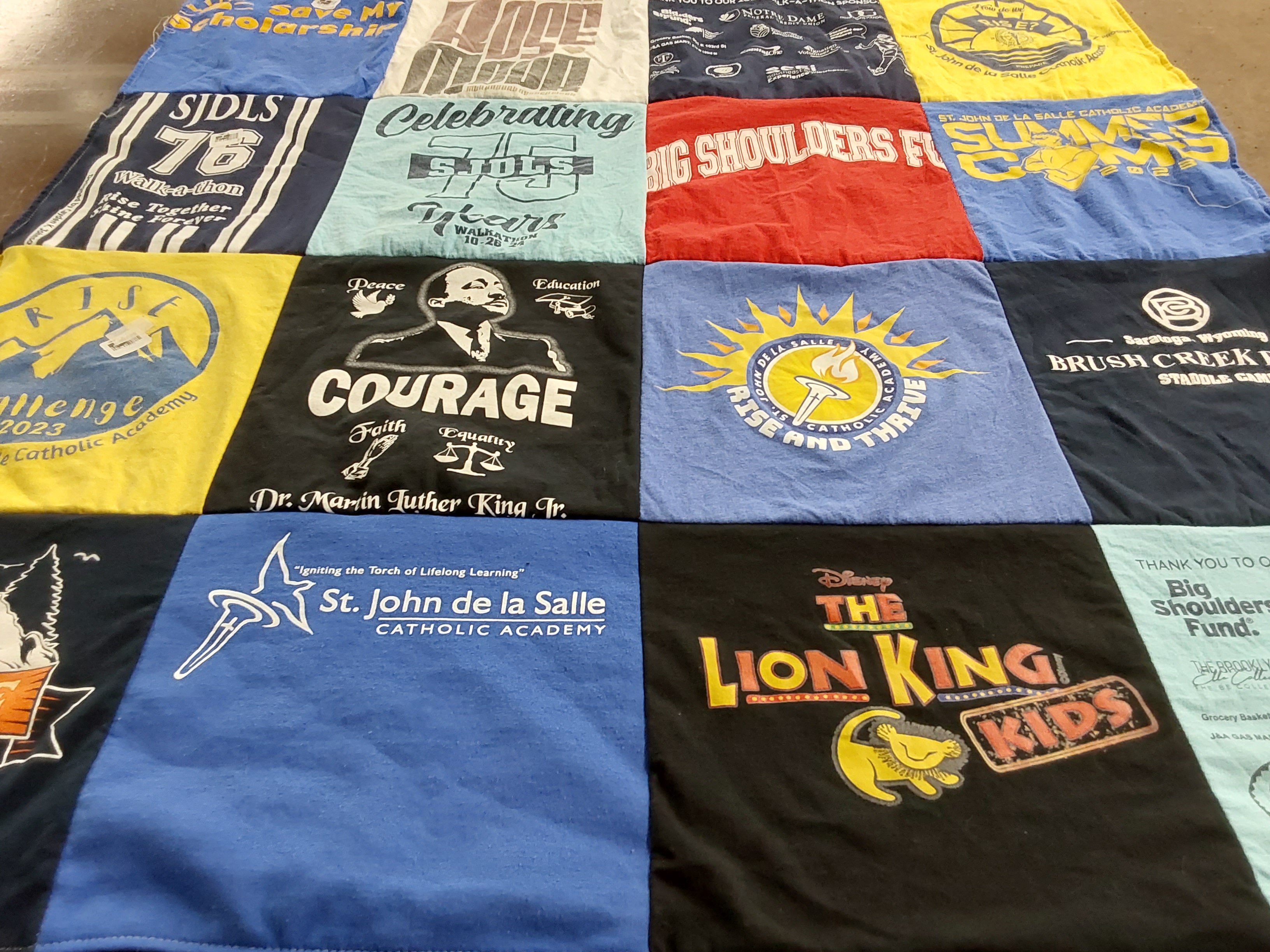 T-shirt quilt from st. john de la salle catholic academy by Sally from IN