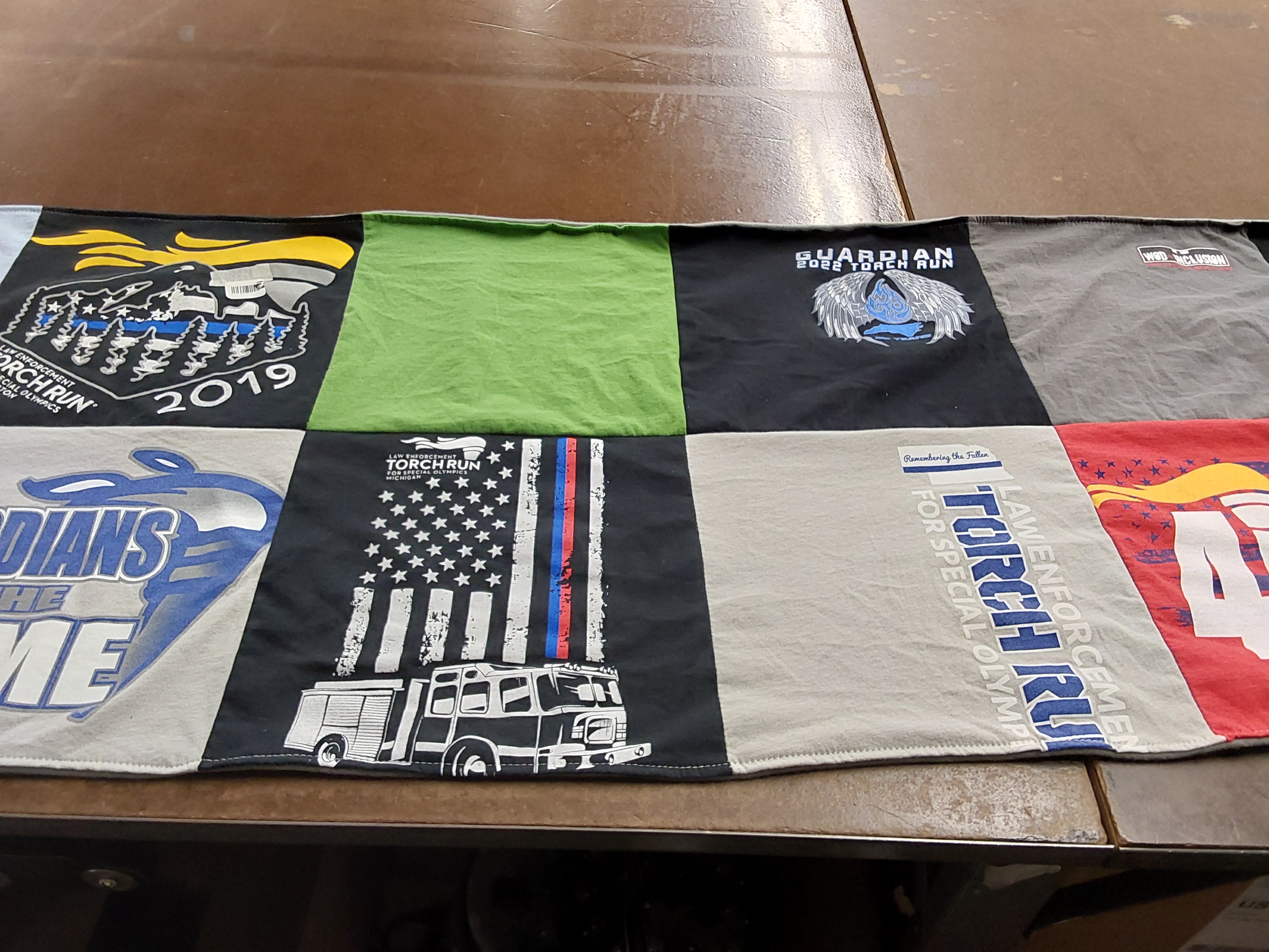 T-shirt quilt with community service, law enforcement themes by Robin from NC