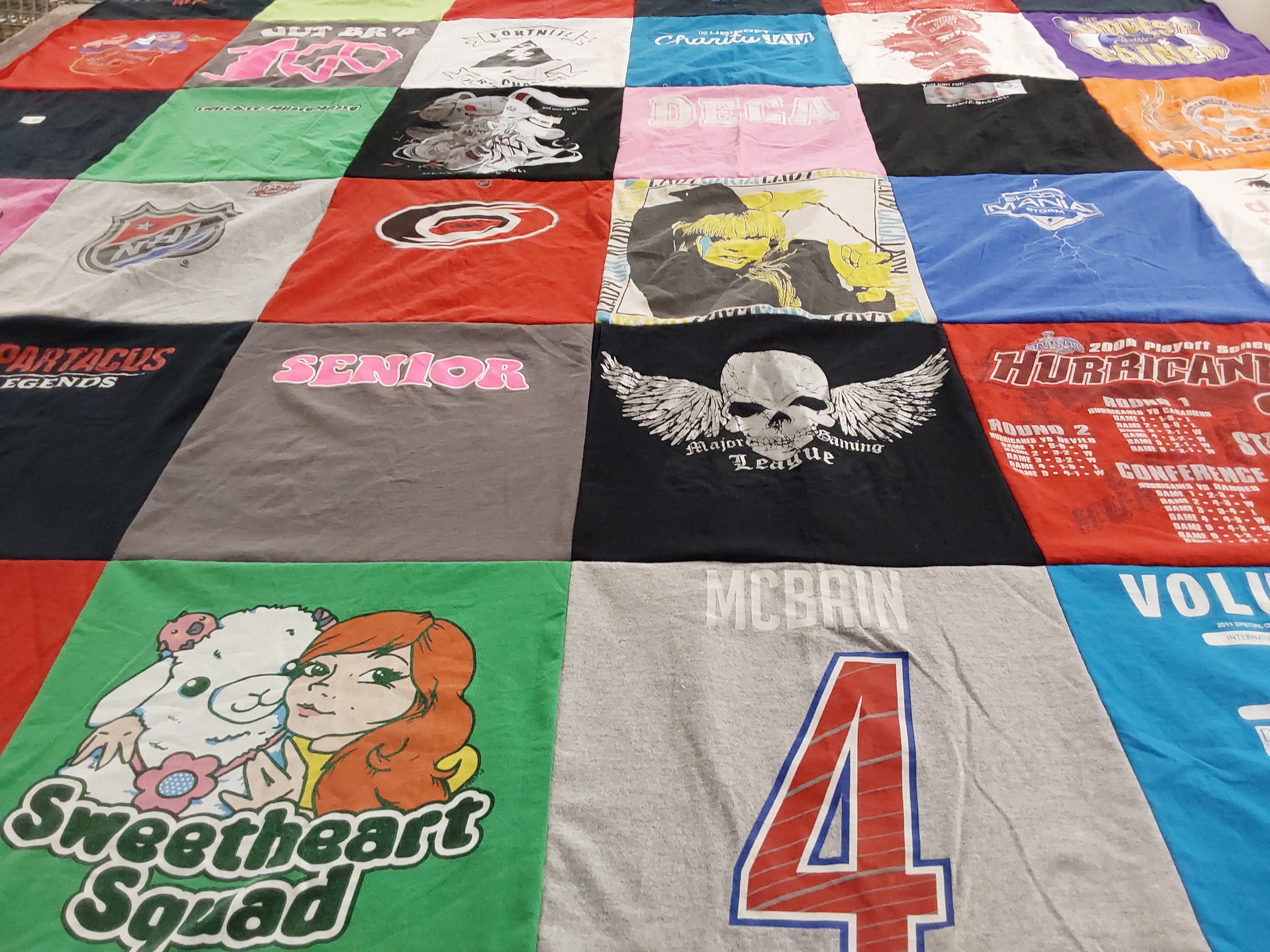T-shirt quilt with gaming, sports themes by Gail from NC