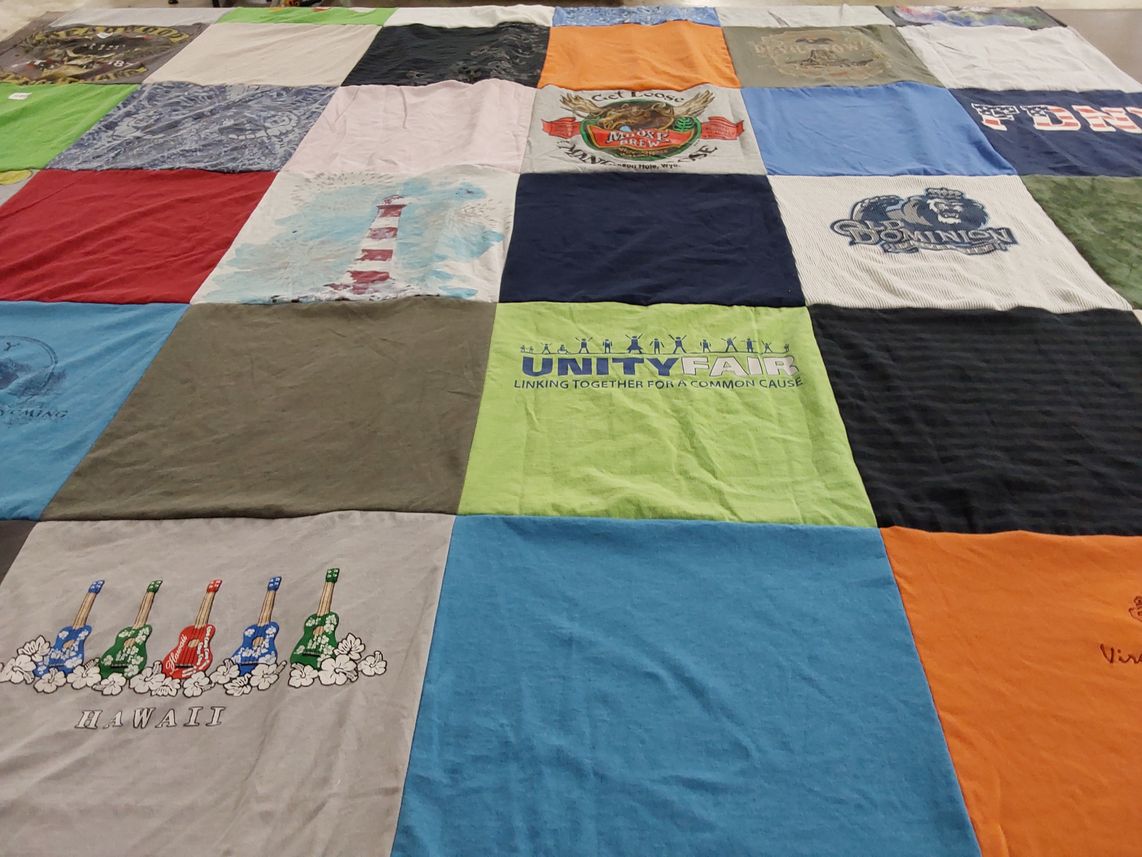 T-shirt quilt with community service themes by Christine from MD