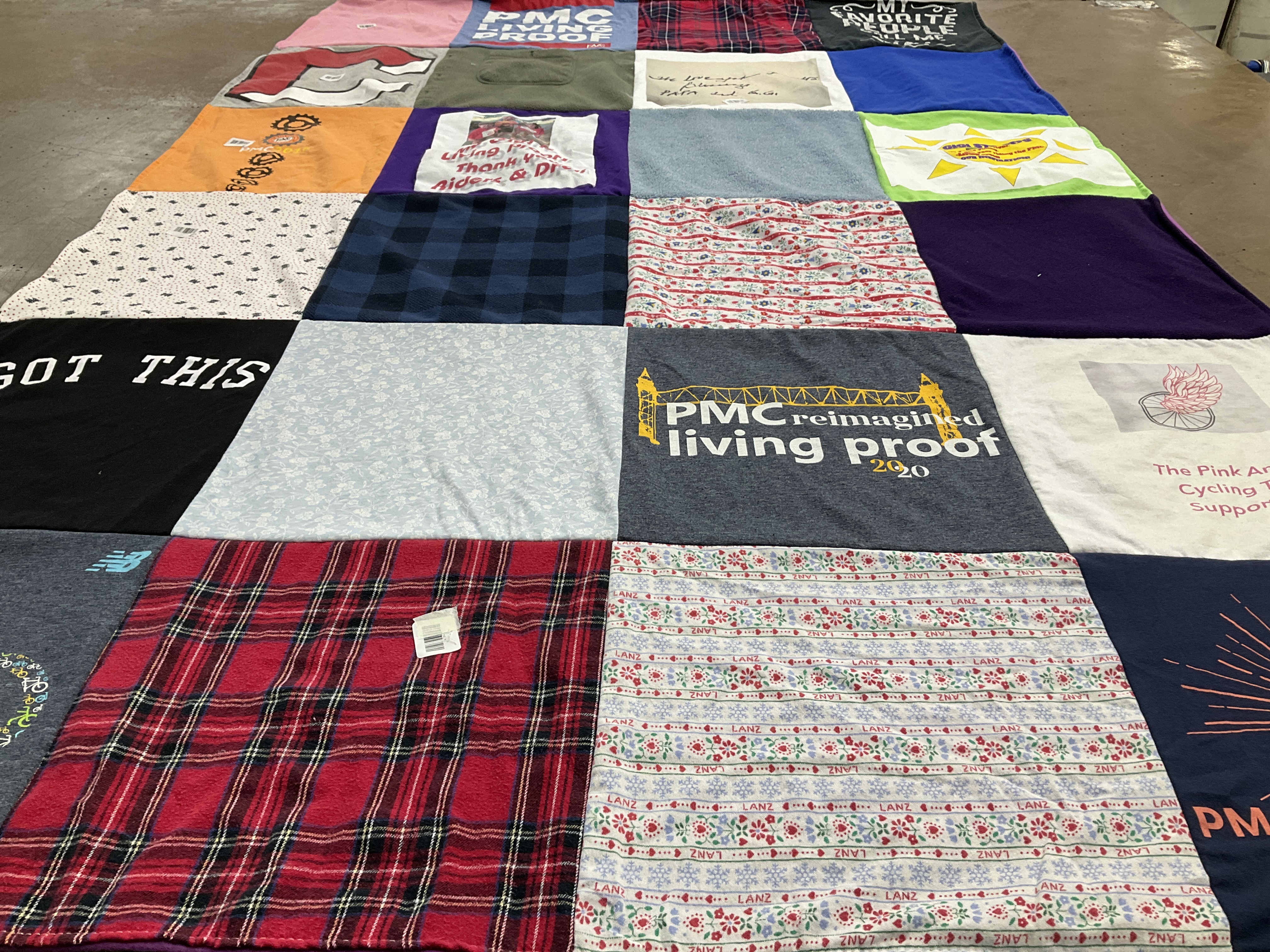 T-shirt quilt with cycling, supporting causes themes by Heather from MA