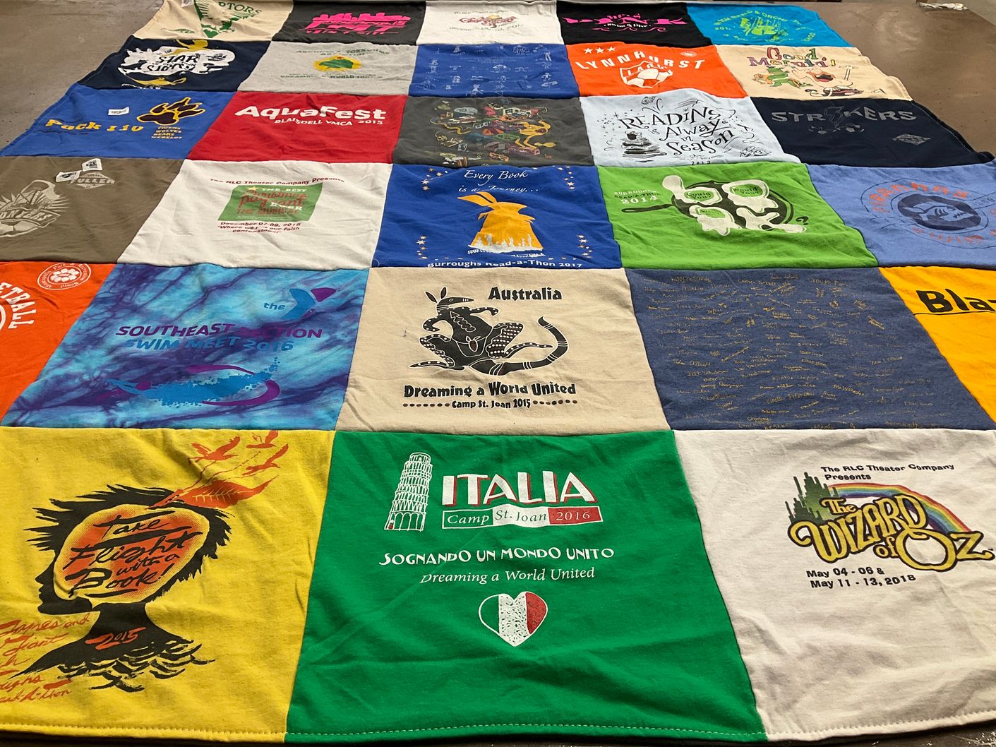 T-shirt quilt with theater, reading themes by Erin from MN