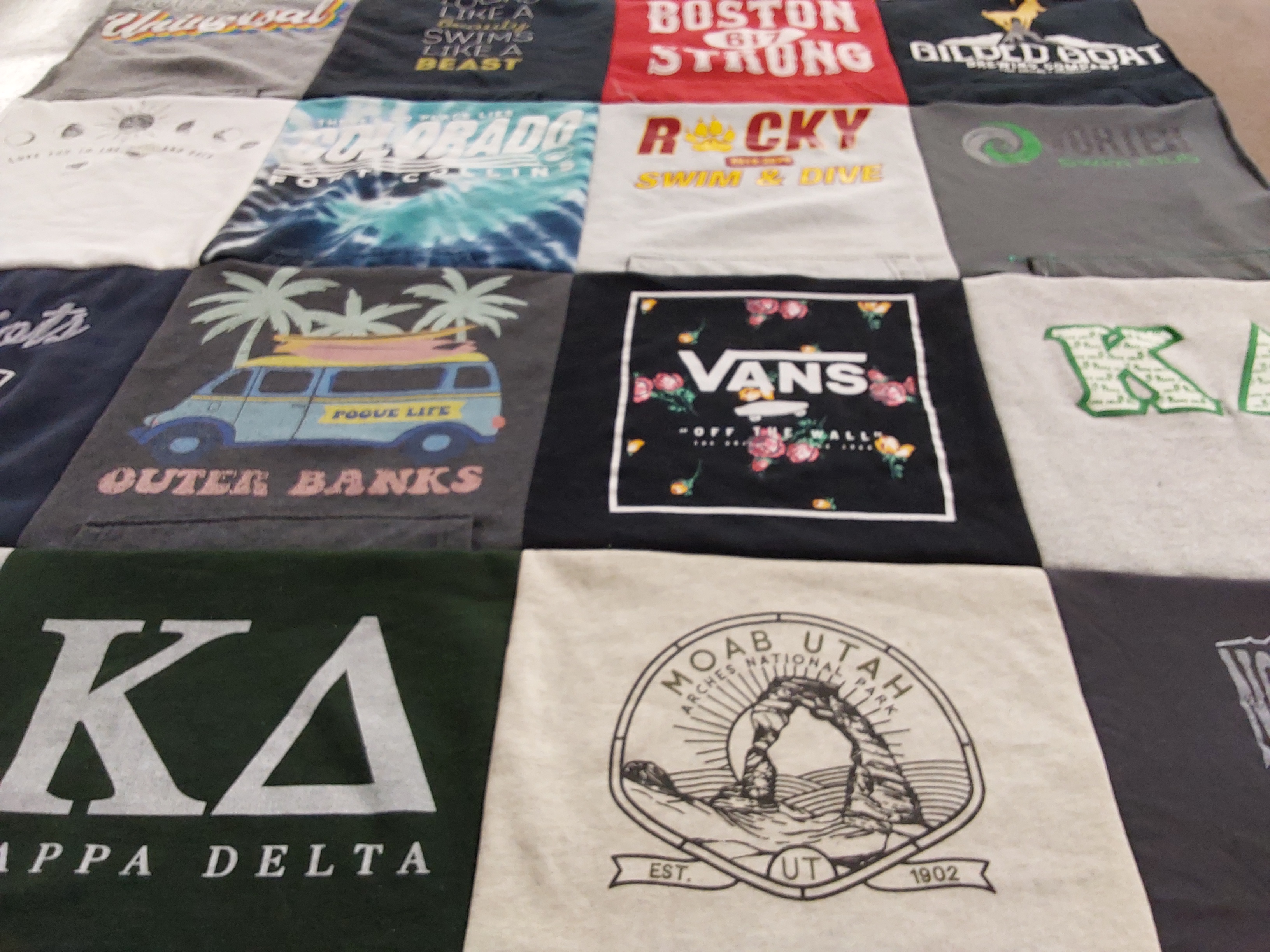 T-shirt quilt with travel, swimming themes by Michael from CO