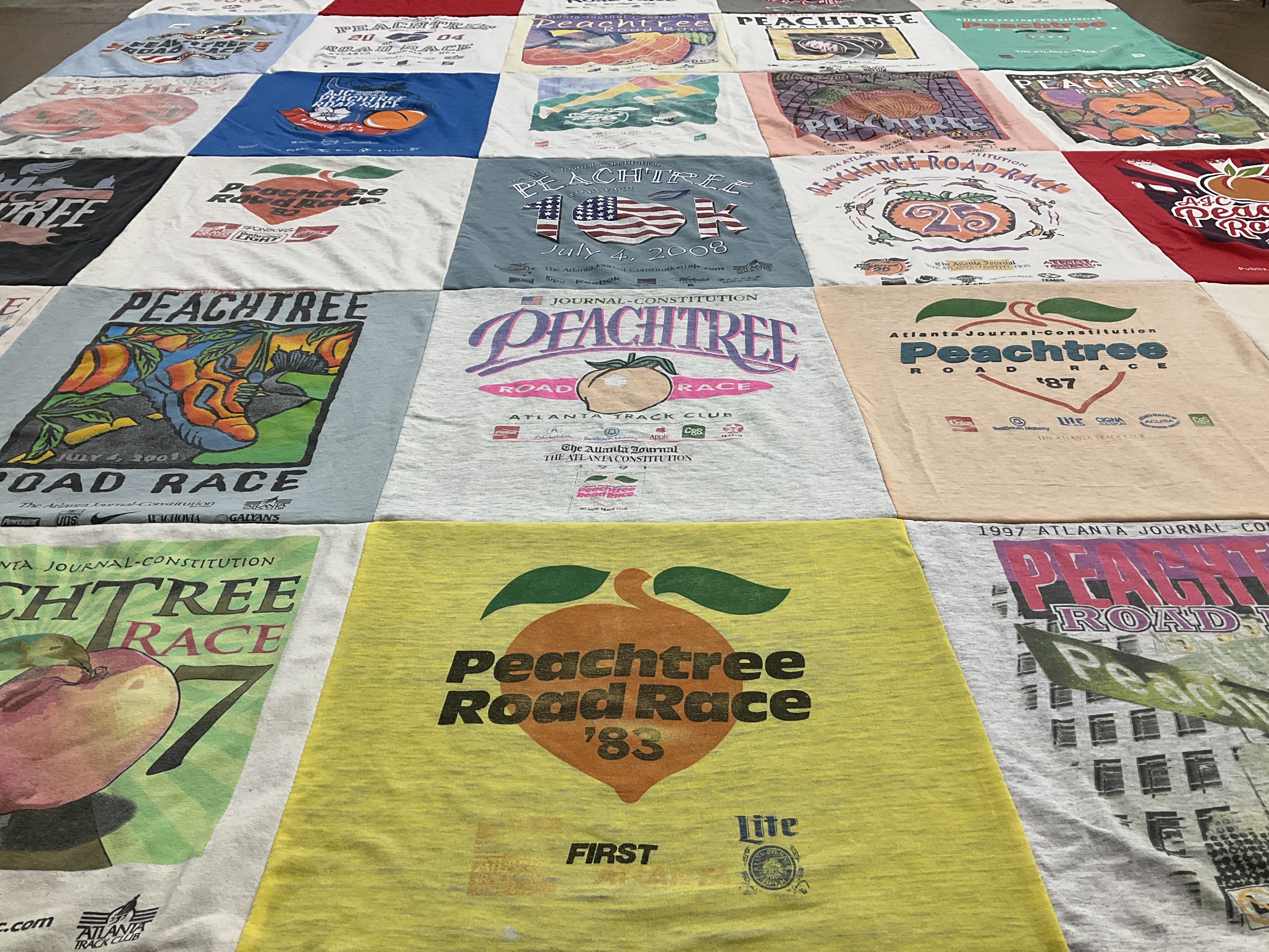 T-shirt quilt with running, sports themes by Mary from GA