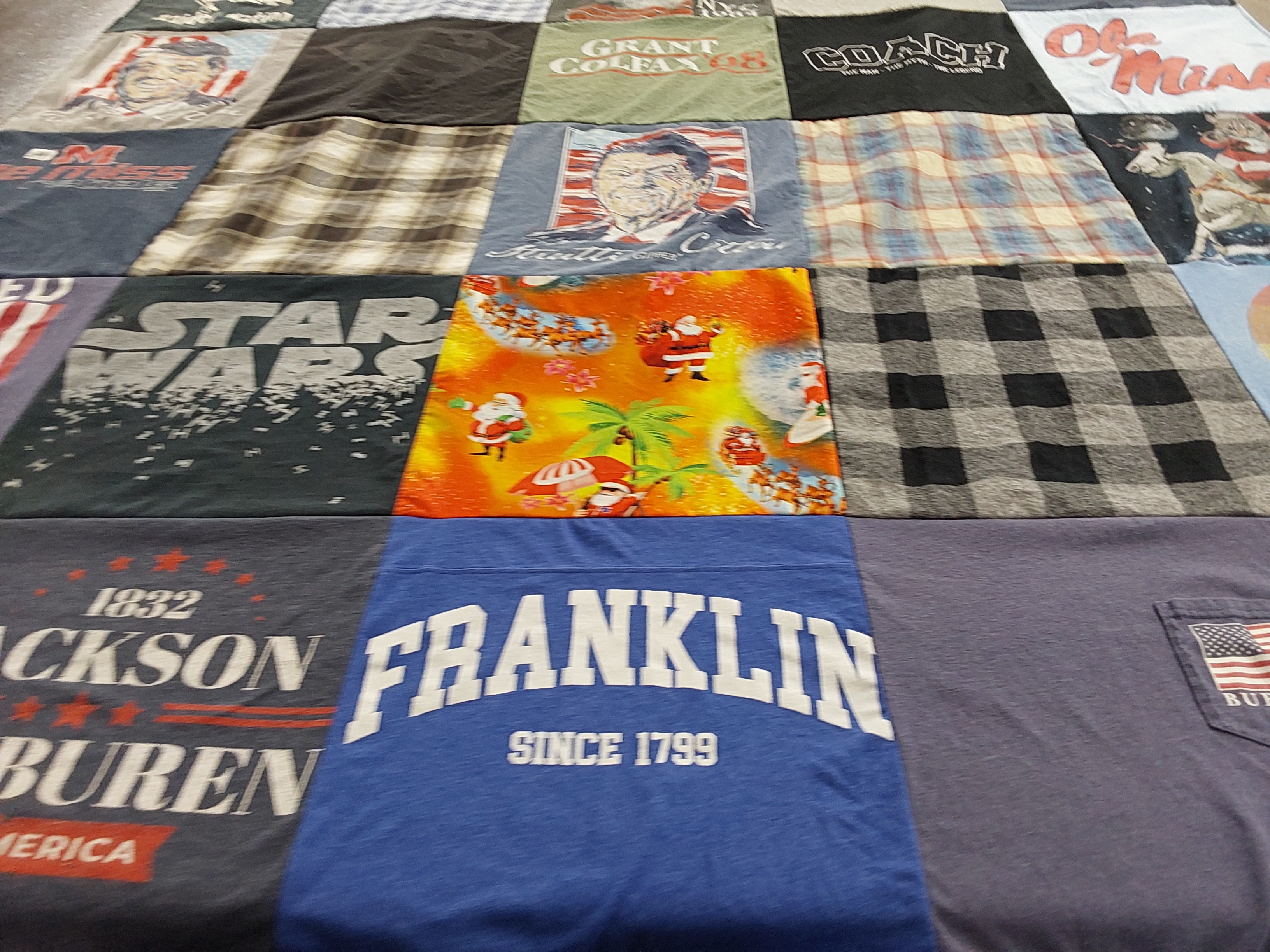 T-shirt quilt with star wars, sports themes by Dana from TN