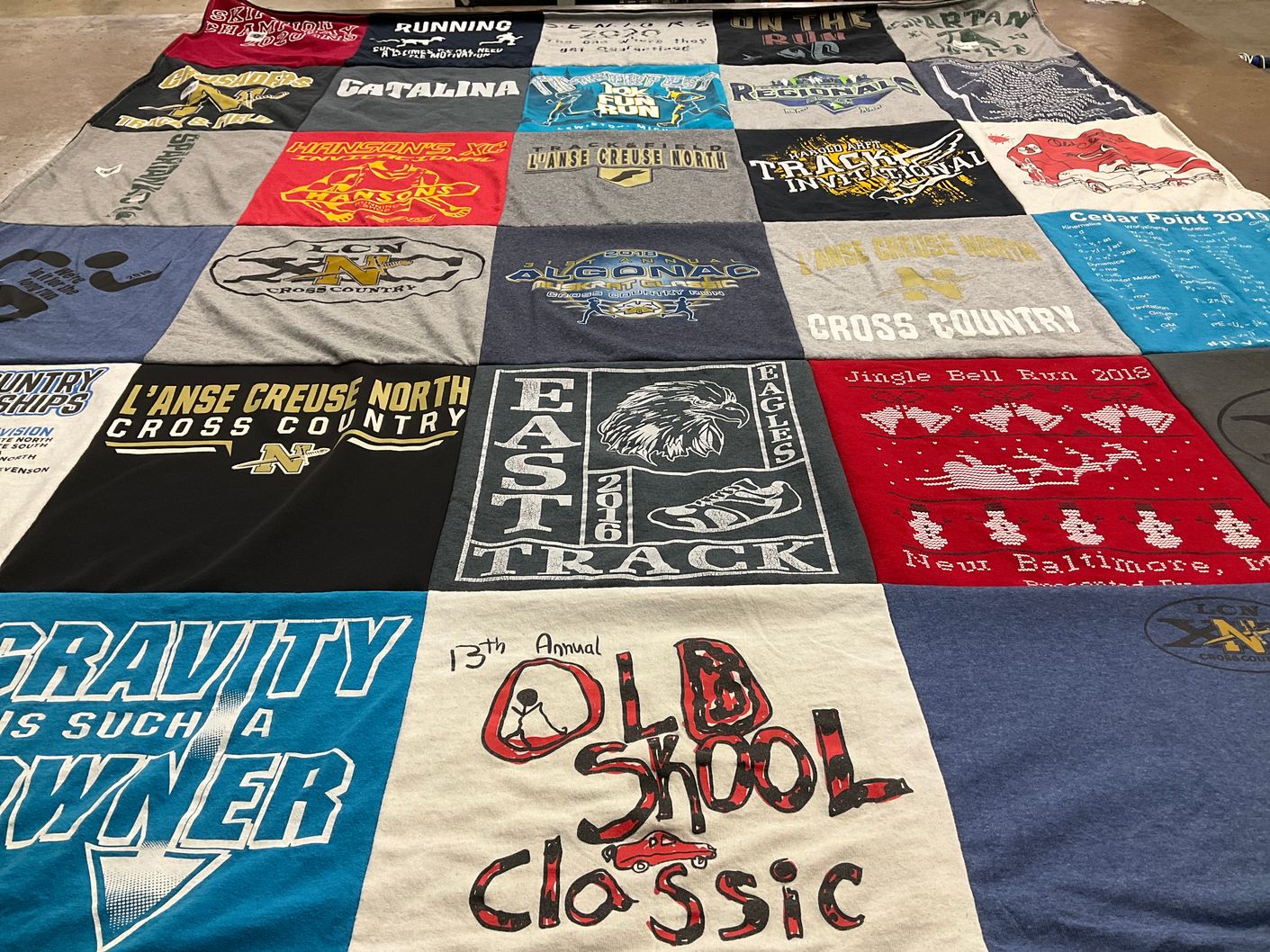 T-shirt quilt featuring l'anse creuse north cross country, east track team by Victoria from MI