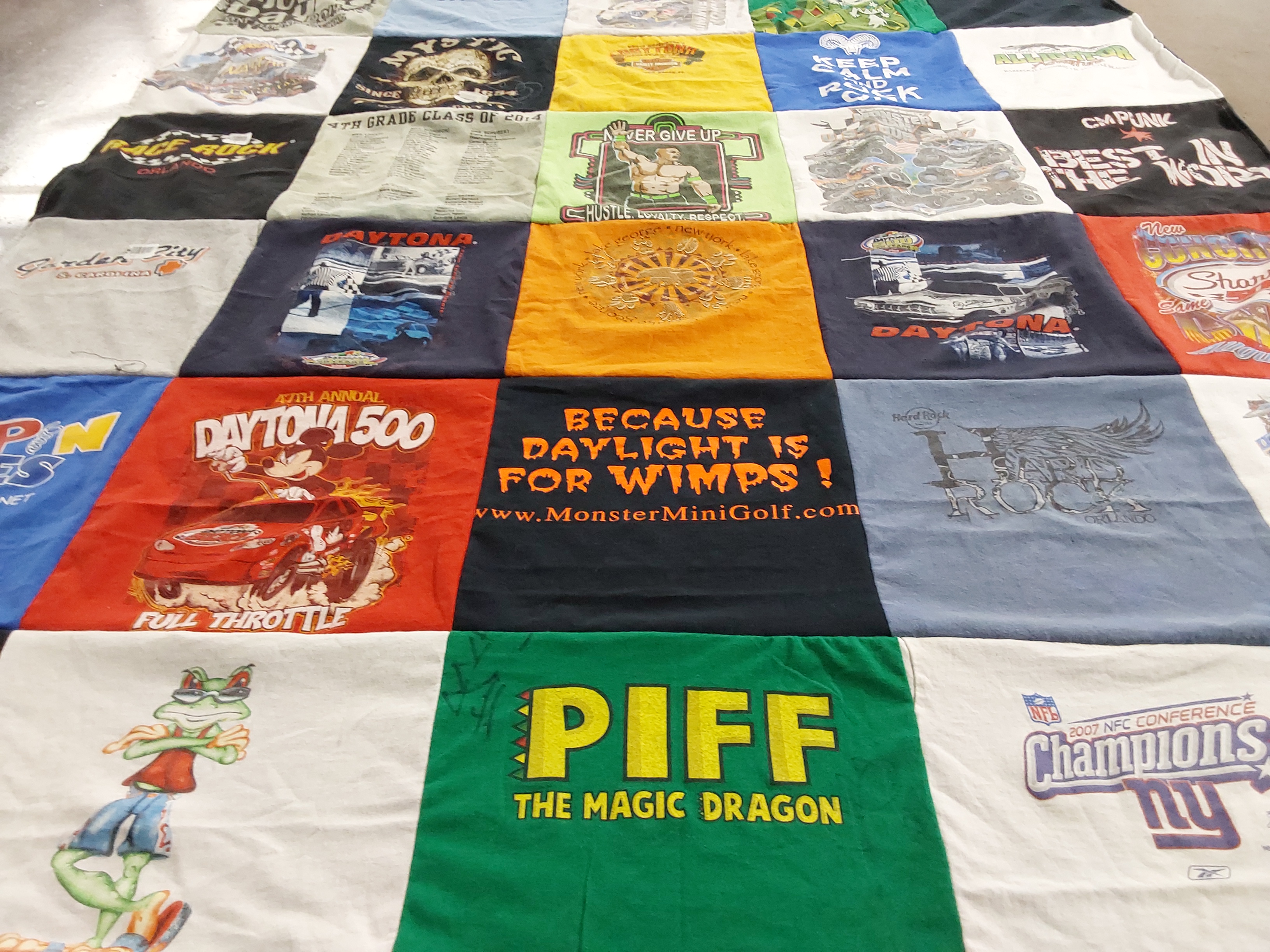 T-shirt quilt with mini golf, racing themes by Kari from NY