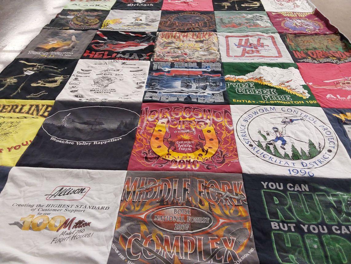 T-shirt quilt with firefighting, nature themes by Eileen from AZ