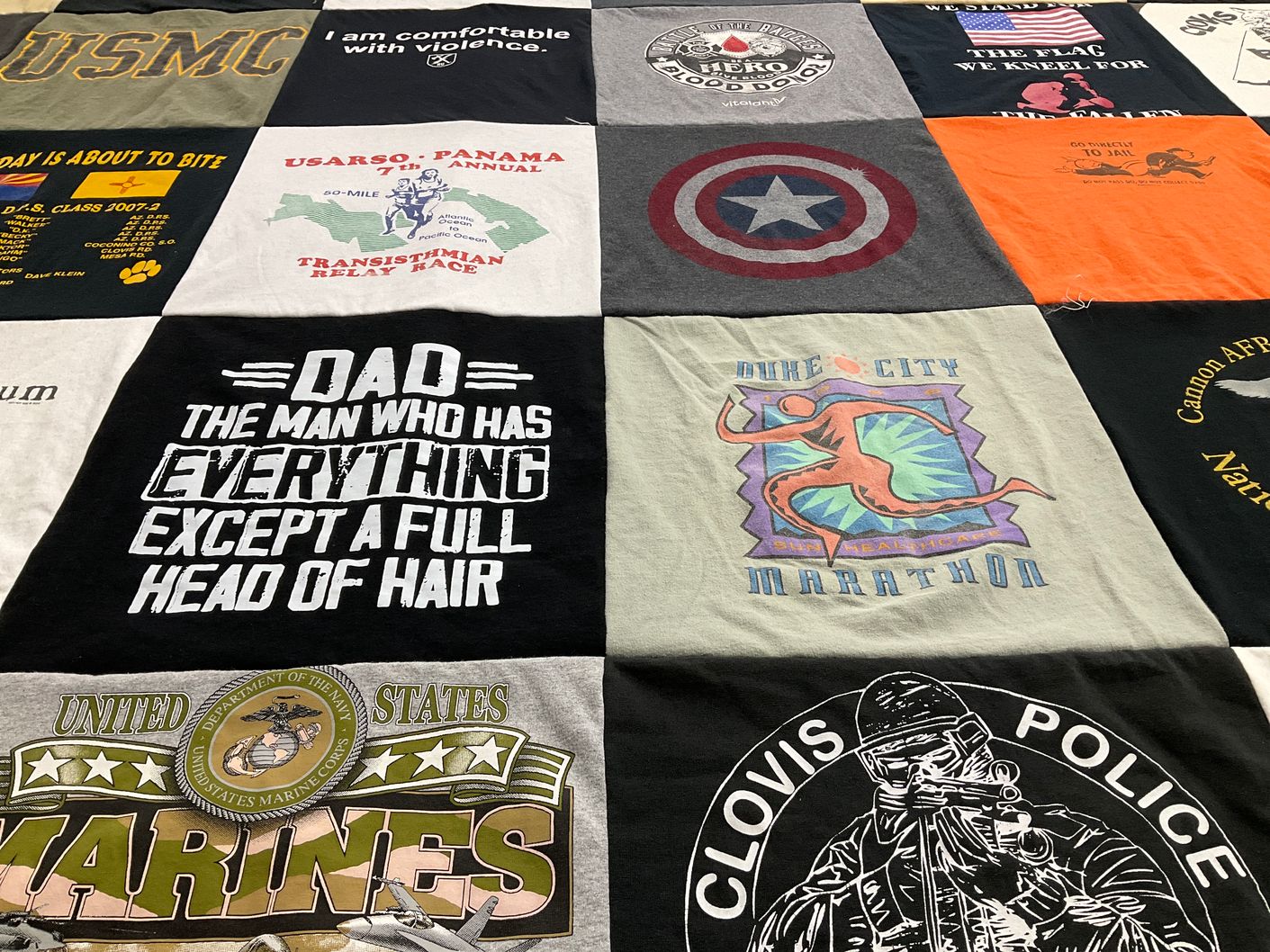 T-shirt quilt with running, military themes by Erica from NM