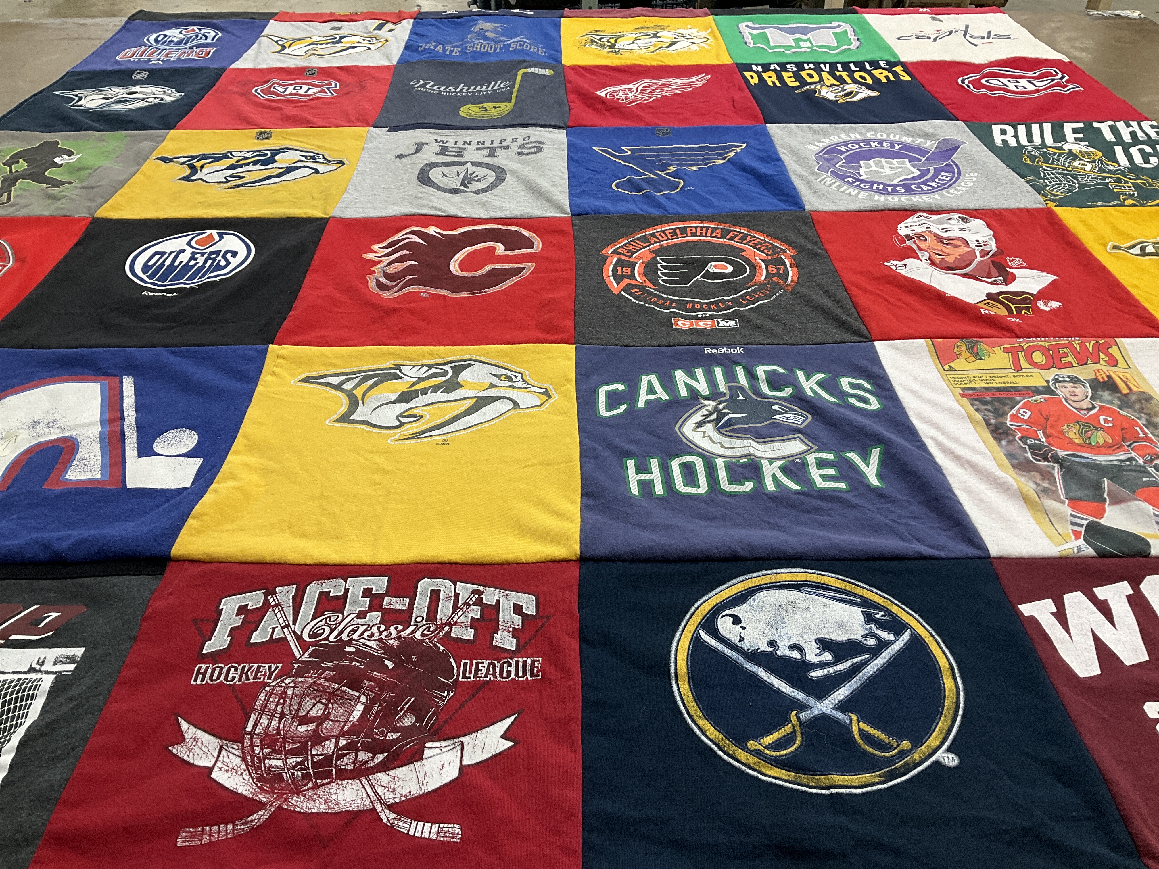 T-shirt quilt with hockey, sports themes by Marsha from KY