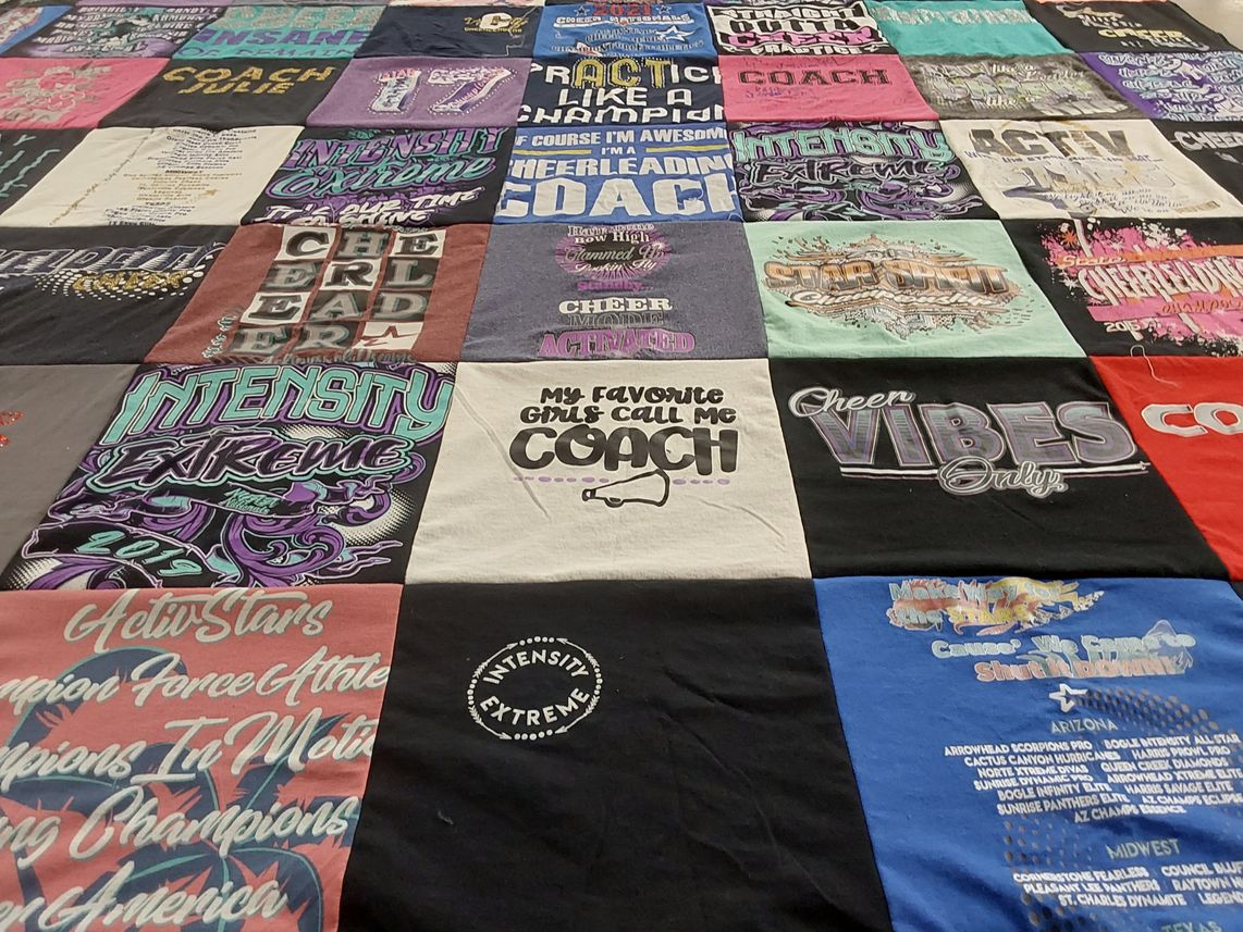 T-shirt quilt with cheerleading themes by Julie from TX