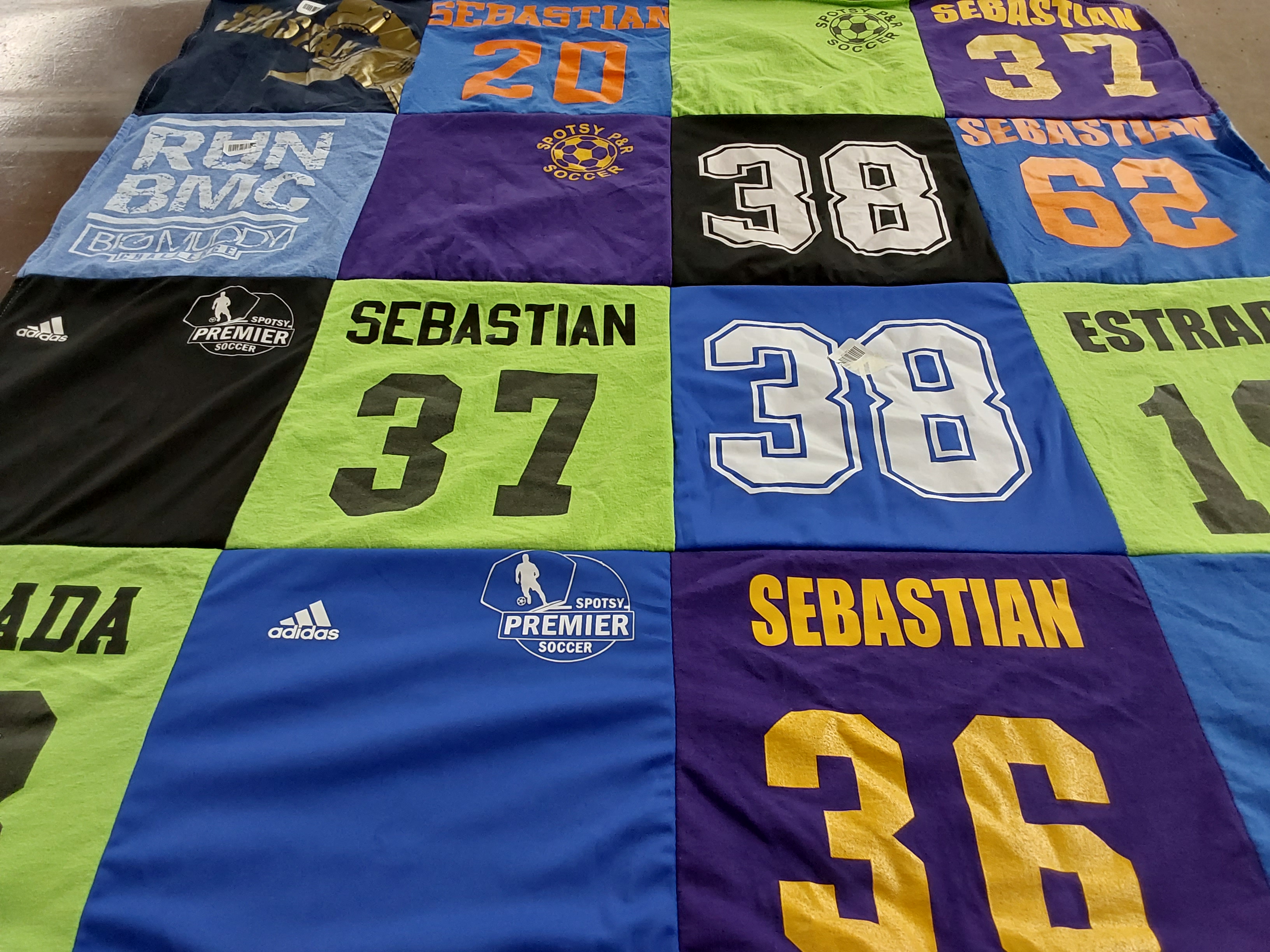 T-shirt quilt with soccer, running themes by Amy from VA