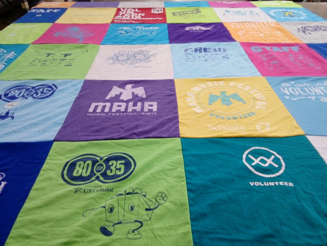 T-shirt quilt with music festivals, volunteering themes by Molly from IA