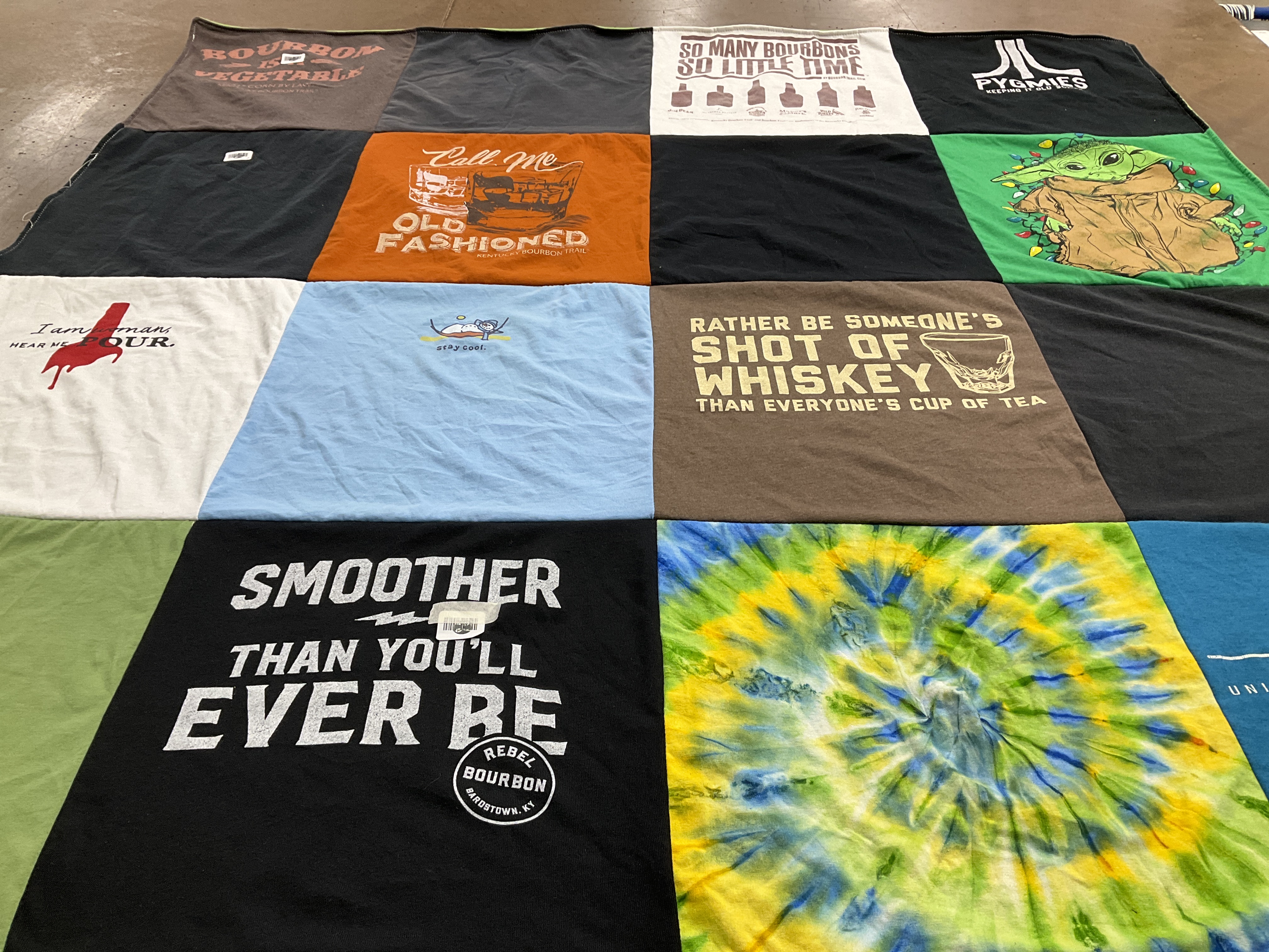 T-shirt quilt with bourbon, whiskey themes by Tina from CA