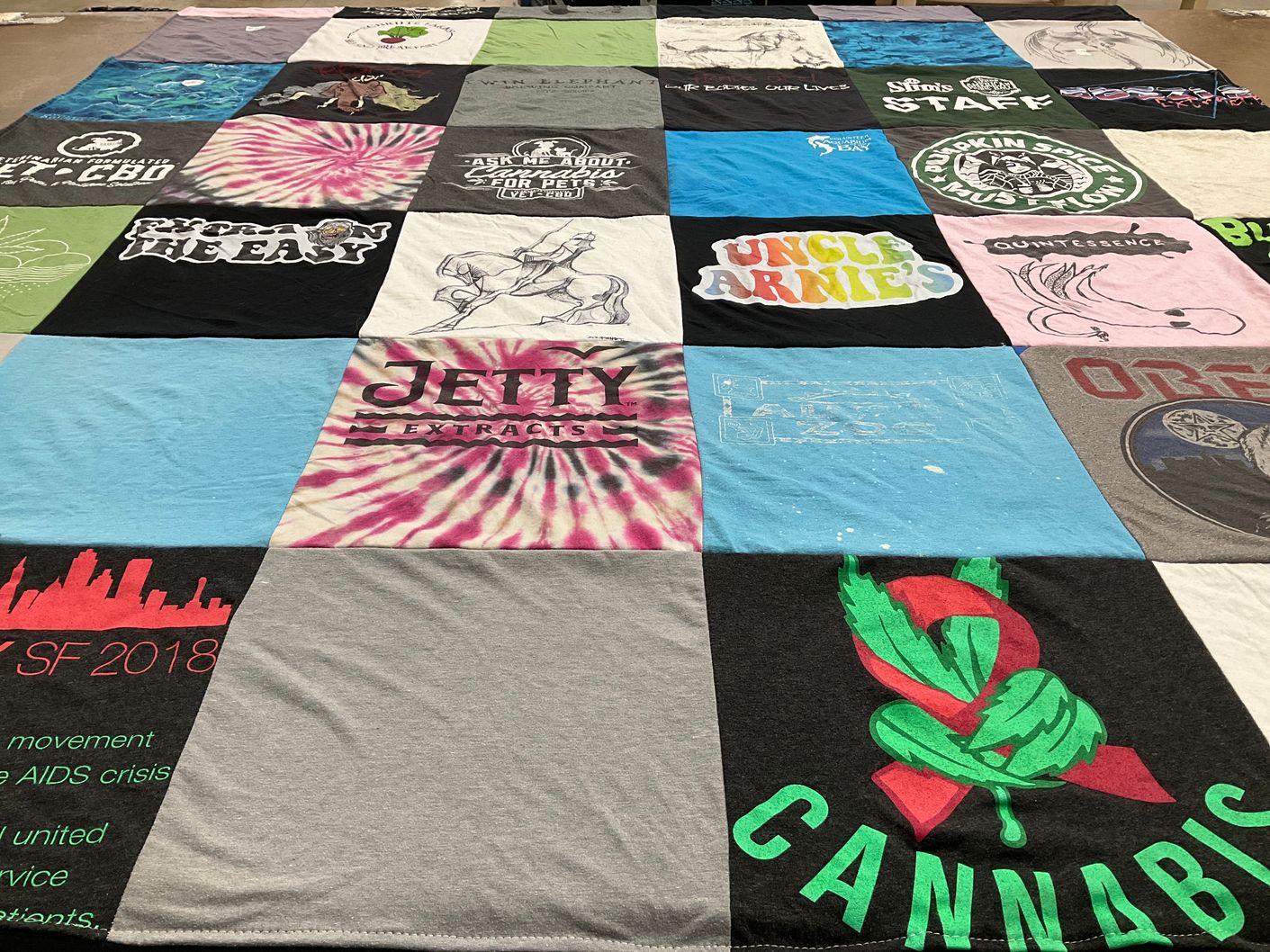 T-shirt quilt with cannabis culture, community service themes by Catherine from CA