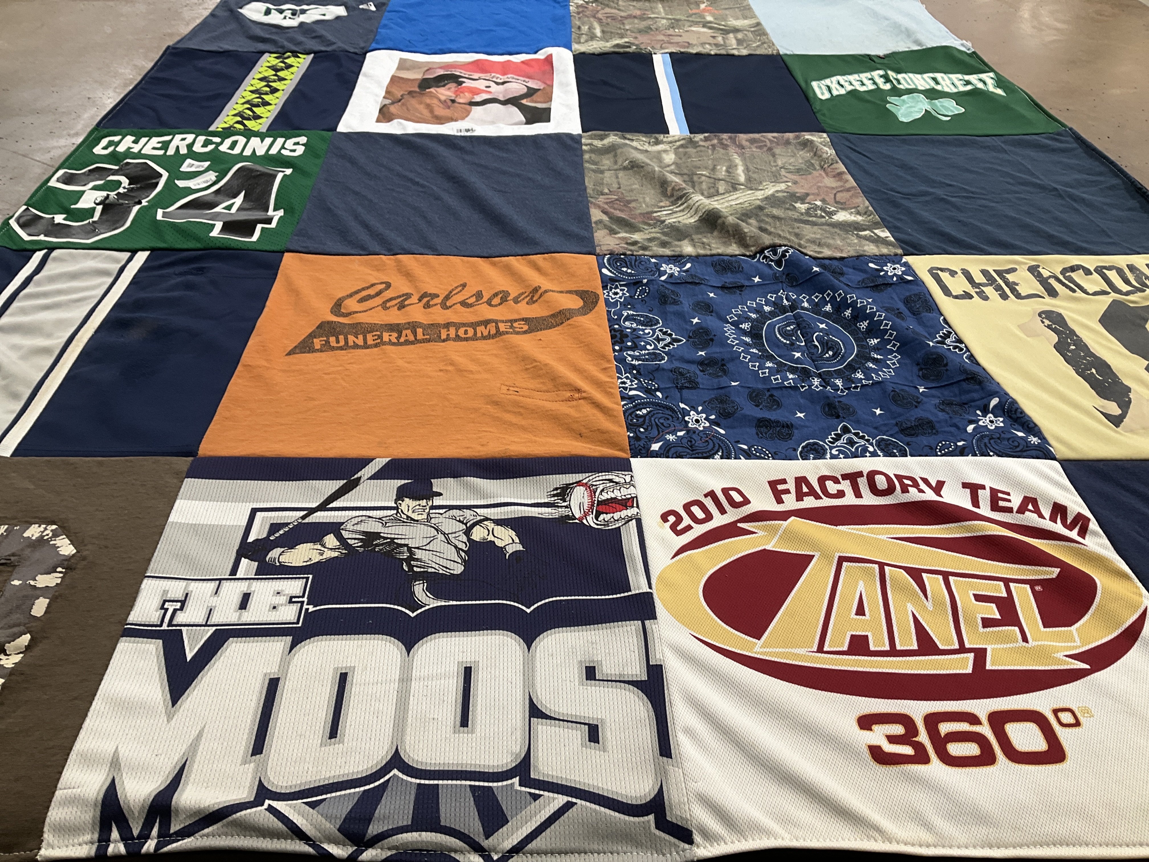T-shirt quilt with sports, funeral services themes by Denise from OH