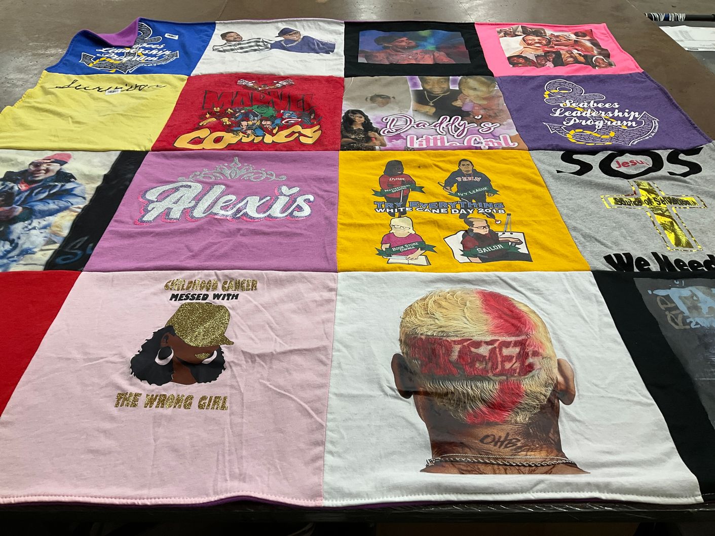 T-shirt quilt with superheroes, community leadership themes by Kym from WI