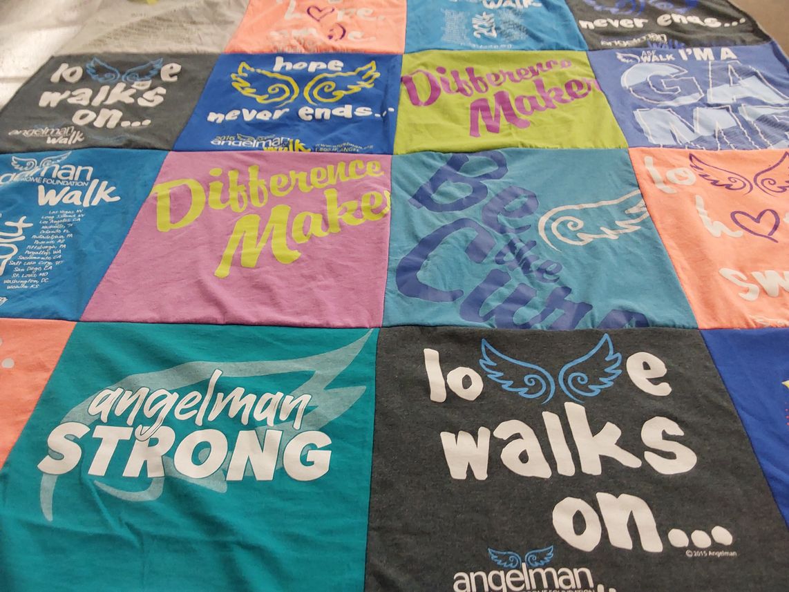 T-shirt quilt with charity, community themes by Pamela L from PA