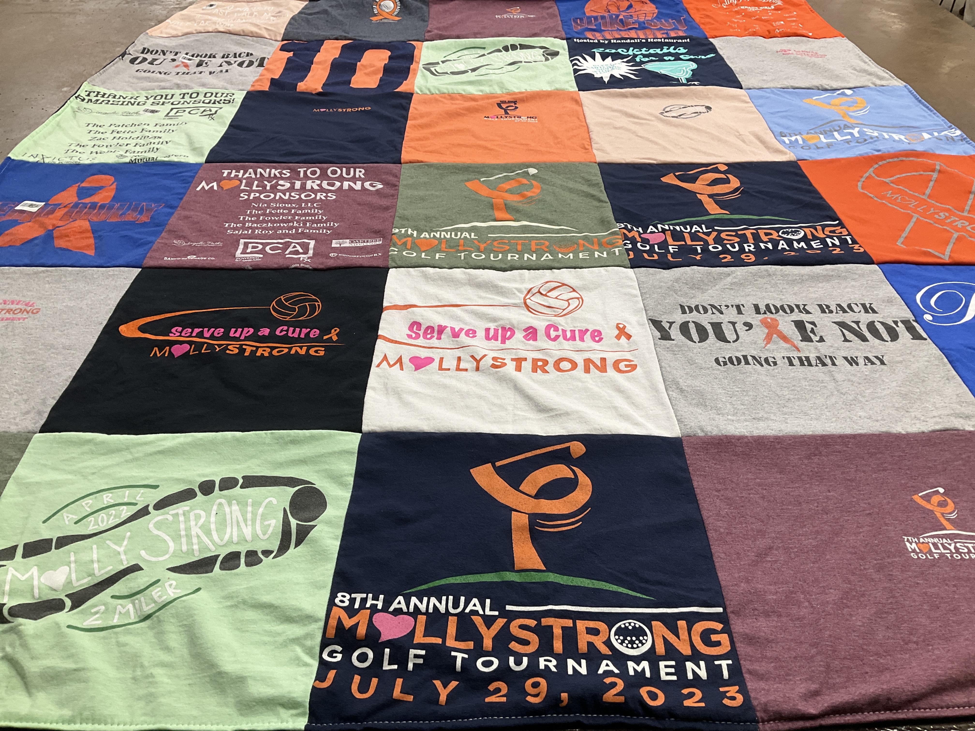T-shirt quilt with charity, sports themes by Lois from PA