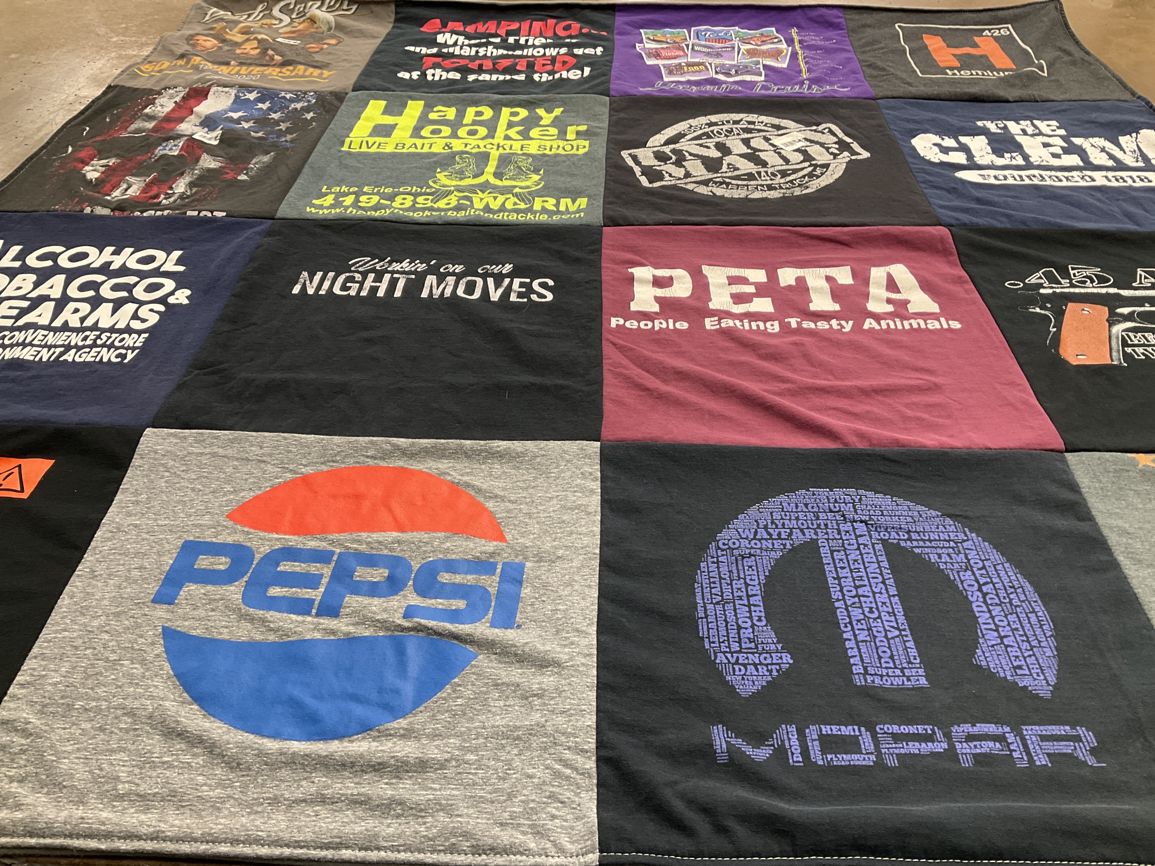 T-shirt quilt with fishing, animal rights themes by Amy from MI