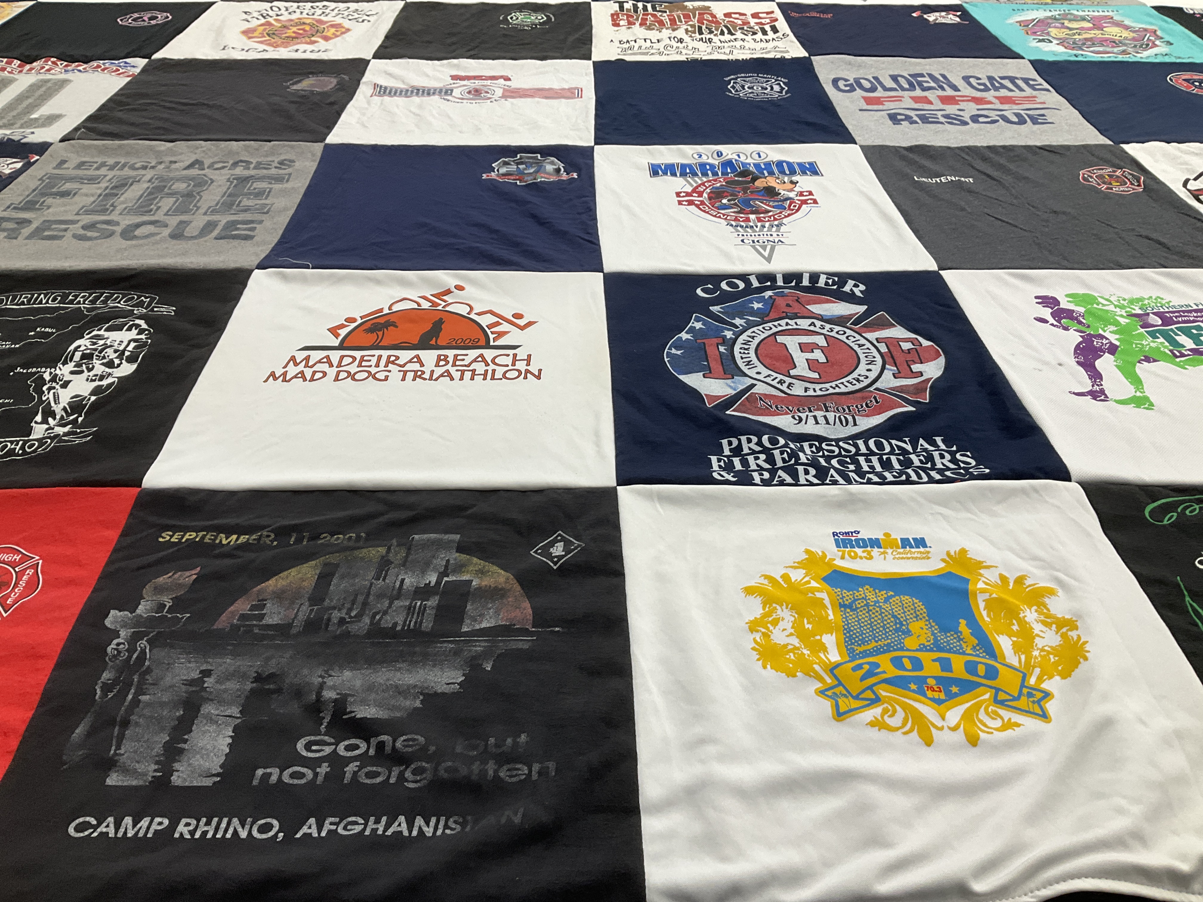 T-shirt quilt with firefighting, triathlons themes by Gayle from FL